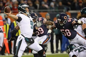 CHICAGO, IL - JANUARY 06:  Nick Foles #9 of the Philadelphia Eagles passes under pressure from Khalil Mack #52 of the Chicago Bears during an NFC Wild Card playoff game at Soldier Field on January 6, 2019 in Chicago, Illinois. The Eagles defeated the Bear