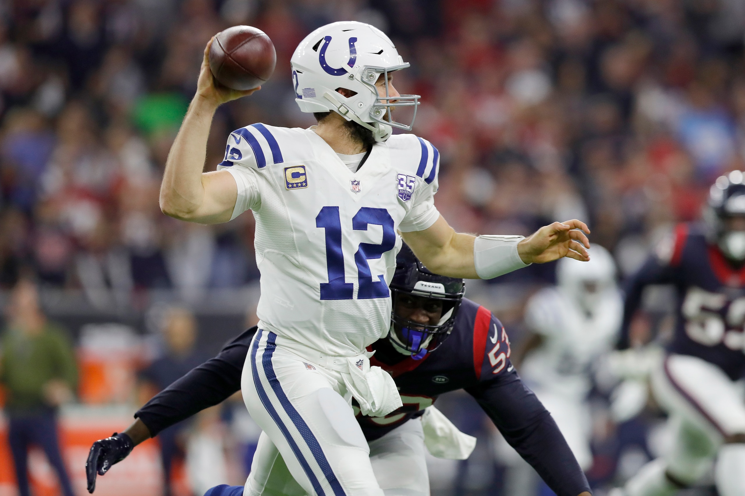 HOUSTON, TX - JANUARY 05: Andrew Luck #12 of the Indianapolis Colts looks to pass under pressure by Duke Ejiofor #53 of the Houston Texans in the third quarter during the Wild Card Round at NRG Stadium on January 5, 2019 in Houston, Texas. (Photo by Tim HOUSTON, TX - JANUARY 05: Andrew Luck #12 of the Indianapolis Colts looks to pass under pressure by Duke Ejiofor #53 of the Houston Texans in the third quarter during the Wild Card Round at NRG Stadium on January 5, 2019 in Houston, Texas. (Photo by Tim