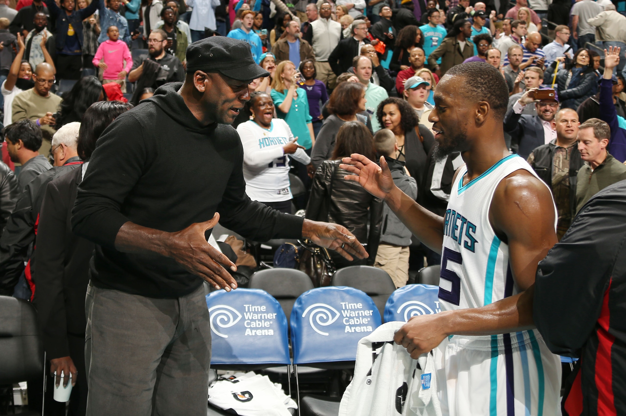 CHARLOTTE, NC - NOVEMBER 25: Hornets owner Michael Jordan high fives Kemba Walker #15 after the game against the Washington Wizards during the game on November 25, 2015 at Time Warner Cable Arena in Charlotte, North Carolina. NOTE TO USER: User expressly 