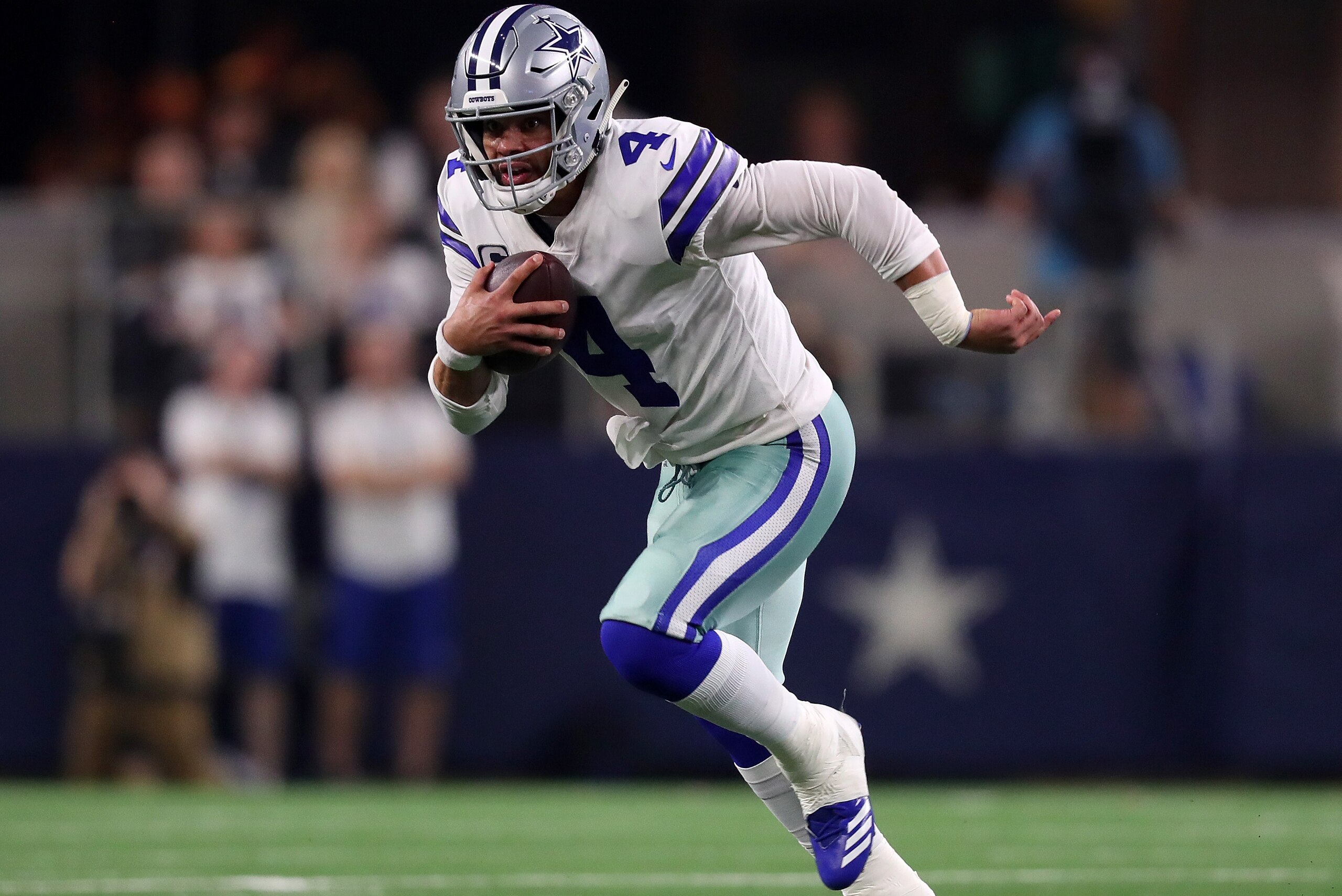 ARLINGTON, TEXAS - JANUARY 05: Dak Prescott #4 of the Dallas Cowboys runs the ball against the Seattle Seahawks in the fourth quarter during the Wild Card Round at AT&T Stadium on January 05, 2019 in Arlington, Texas. (Photo by Tom Pennington/Getty Images