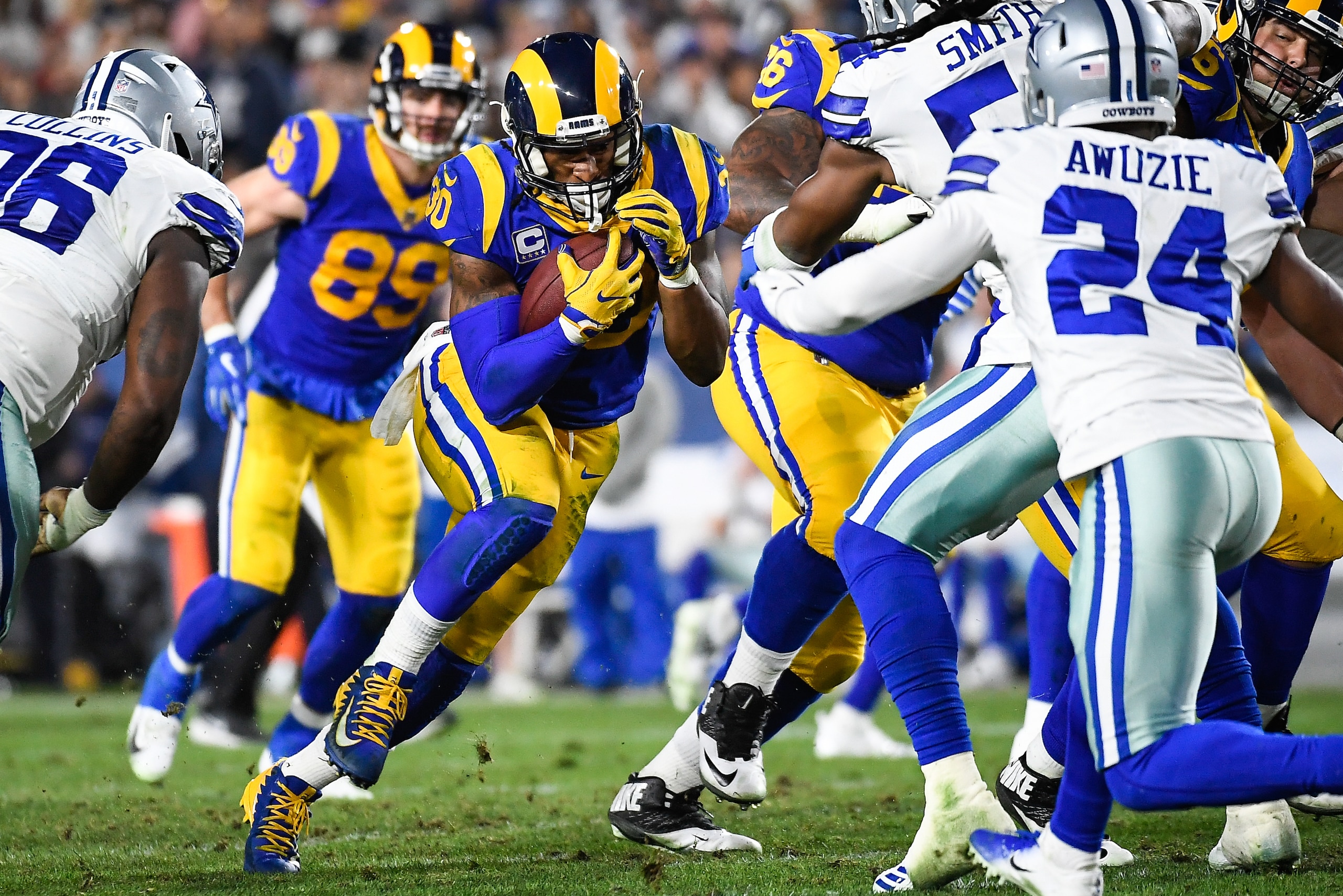 LOS ANGELES, CA - JANUARY 12: Running back Todd Gurley #30 of the Los Angeles Rams rushes for a short gain in the second quarter against the Dallas Cowboys in the NFC Divisional Round playoff game at Los Angeles Memorial Coliseum on January 12, 2019 in Lo