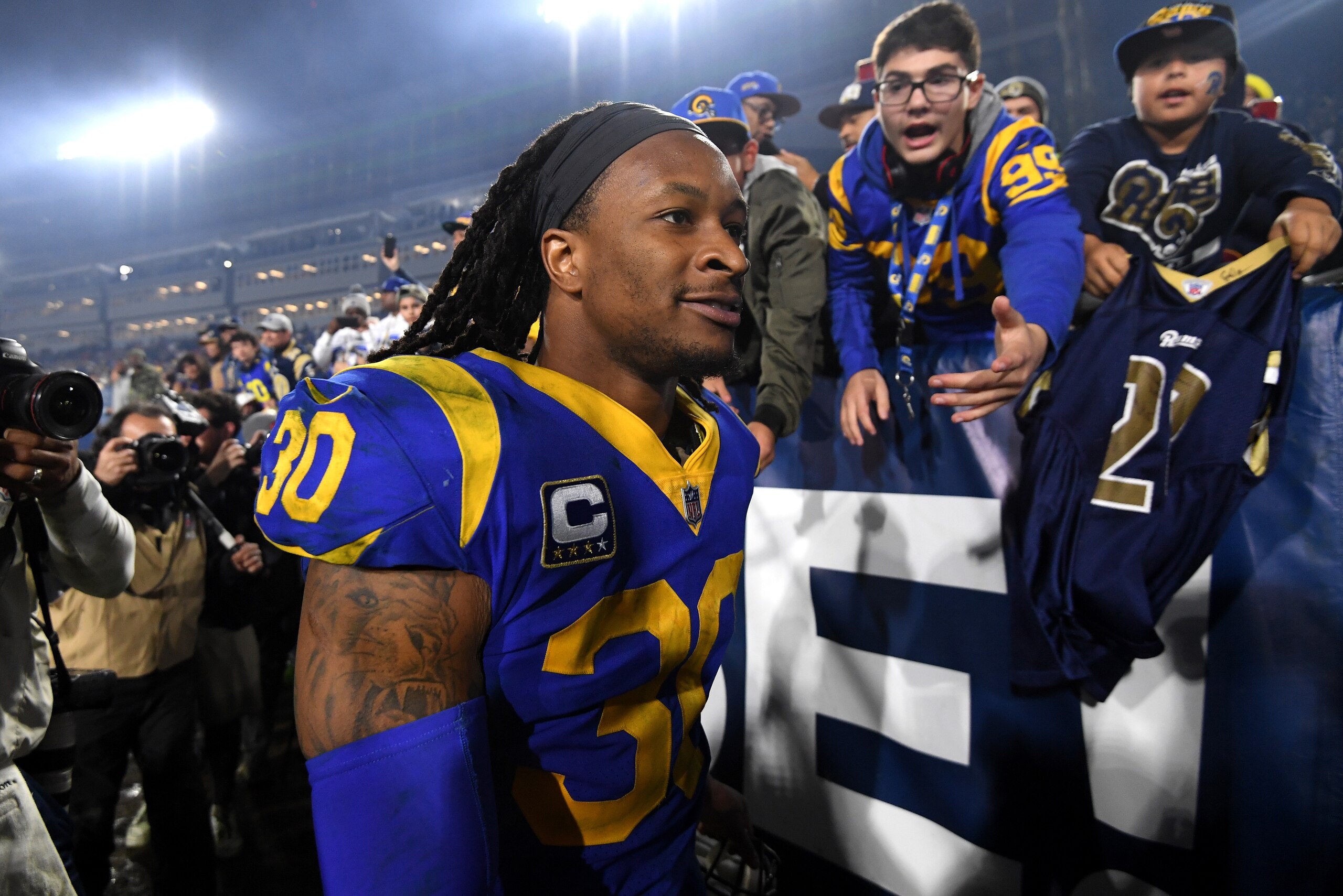 LOS ANGELES, CA - JANUARY 12:  Todd Gurley #30 of the Los Angeles Rams celebrates with fans after defeating the Dallas Cowboys in the NFC Divisional Playoff game at Los Angeles Memorial Coliseum on January 12, 2019 in Los Angeles, California. The Rams def