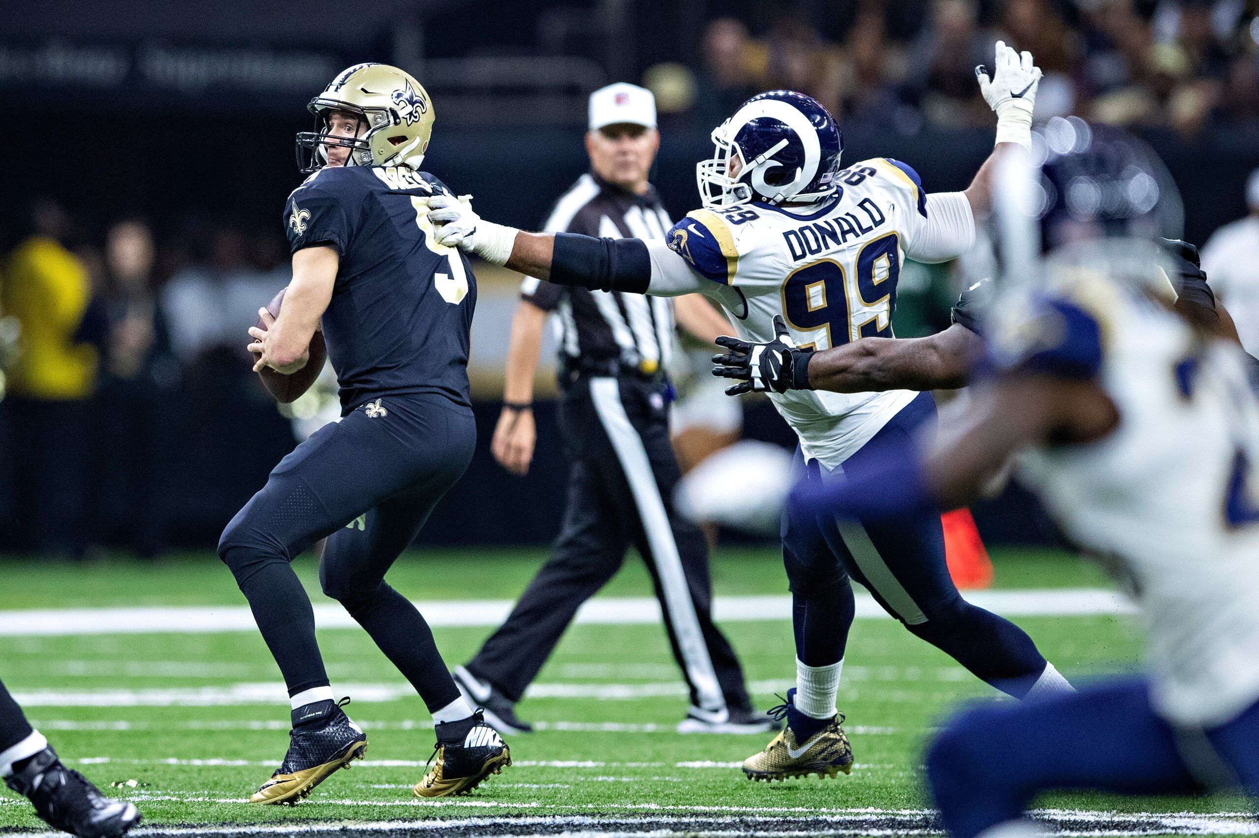 NEW ORLEANS, LA - NOVEMBER 4:  Aaron Donald #99 of the Los Angeles Rams gets a hand on Drew Brees #9 of the New Orleans Saints at Mercedes-Benz Superdome on November 4, 2018 in New Orleans, Louisiana.  The Saints defeated the Rams 45-35.  (Photo by Wesley