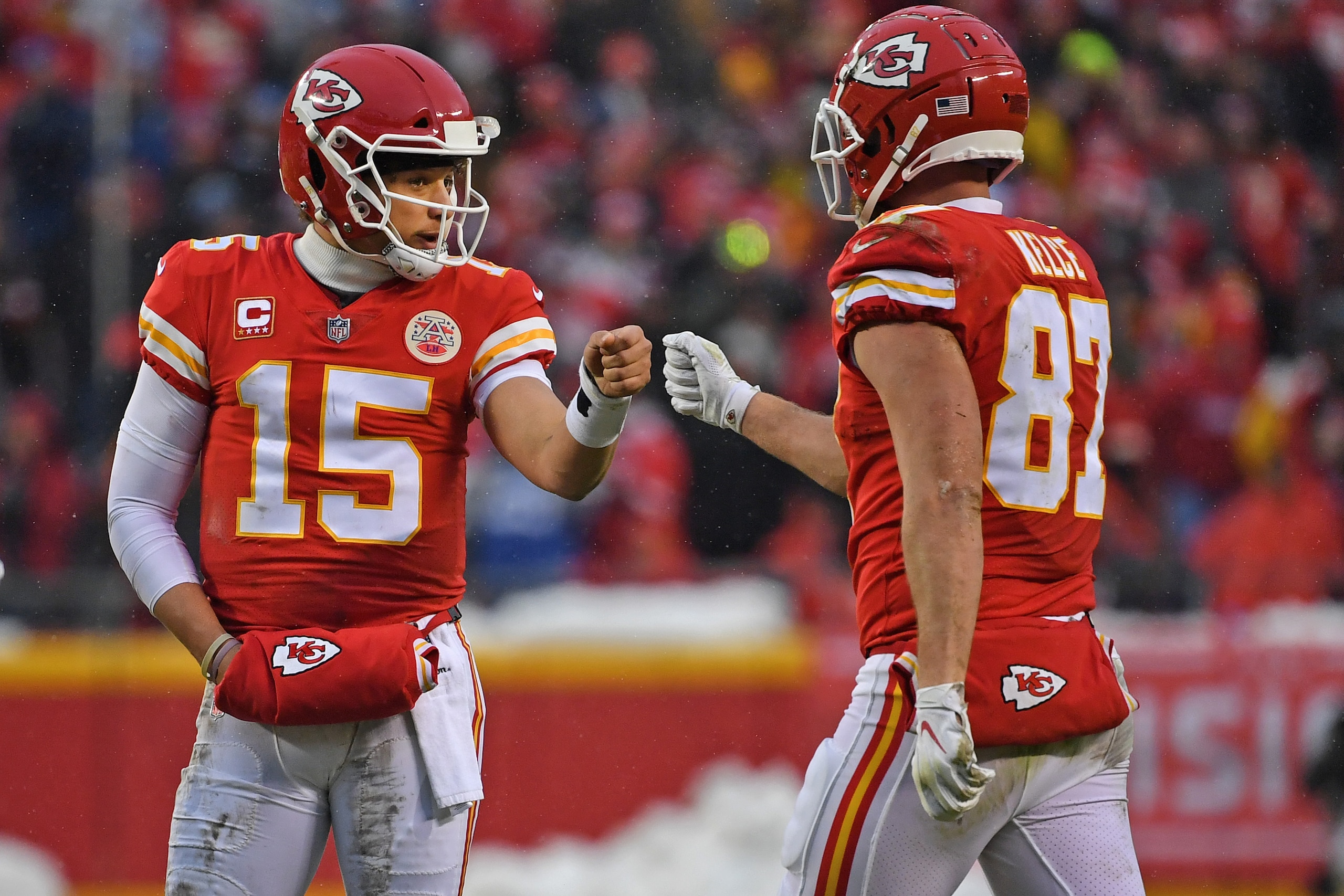 KANSAS CITY, MO - JANUARY 12: Quarterback Patrick Mahomes #15 of the Kansas City Chiefs givs tight end Travis Kelce #87 a fist pump after a play against the Indianapolis Colts, during the first half of the AFC Divisional Round playoff game at Arrowhead St
