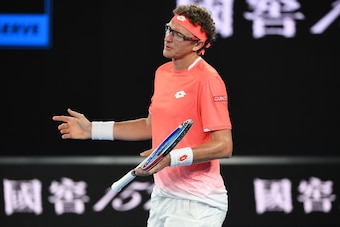Uzbekistan's Denis Istomin reacts after a point against Switzerland's Roger Federer during their men's singles match on day one of the Australian Open tennis tournament in Melbourne on January 14, 2019. (Photo by WILLIAM WEST / AFP) / -- IMAGE RESTRICTED 