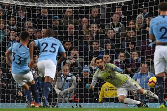 Manchester City's Brazilian striker Gabriel Jesus (L) scores their second goal from the penalty spot past Wolverhampton Wanderers' Portuguese goalkeeper Rui Patricio (C) during the English Premier League football match between Manchester City and Wolverha