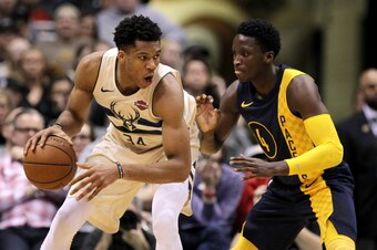 MILWAUKEE, WI - MARCH 02:  Giannis Antetokounmpo #34 of the Milwaukee Bucks dribbles the ball while being guarded by Victor Oladipo #4 of the Indiana Pacers in the fourth quarter at the Bradley Center on March 2, 2018 in Milwaukee, Wisconsin. NOTE TO USER