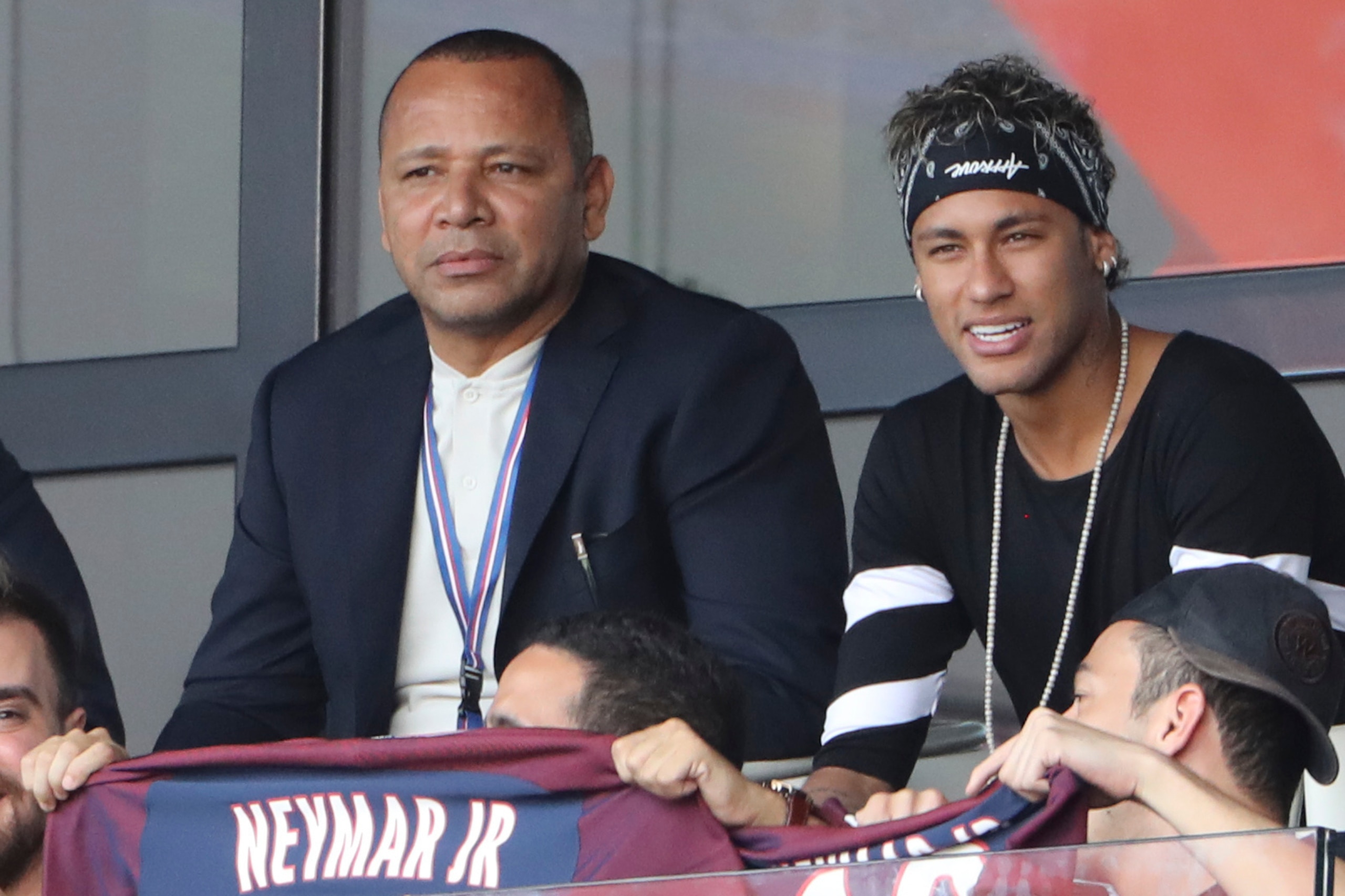 Paris Saint-Germain's Brazilian forward Neymar (C), flanked by his father Neymar Santos (L) and a close friend Jo Amancio, watches the French L1 football match between Paris Saint-Germain (PSG) and Amiens (ASC) at the Parc de Princes Stadium in Paris on A Paris Saint-Germain's Brazilian forward Neymar (C), flanked by his father Neymar Santos (L) and a close friend Jo Amancio, watches the French L1 football match between Paris Saint-Germain (PSG) and Amiens (ASC) at the Parc de Princes Stadium in Paris on A