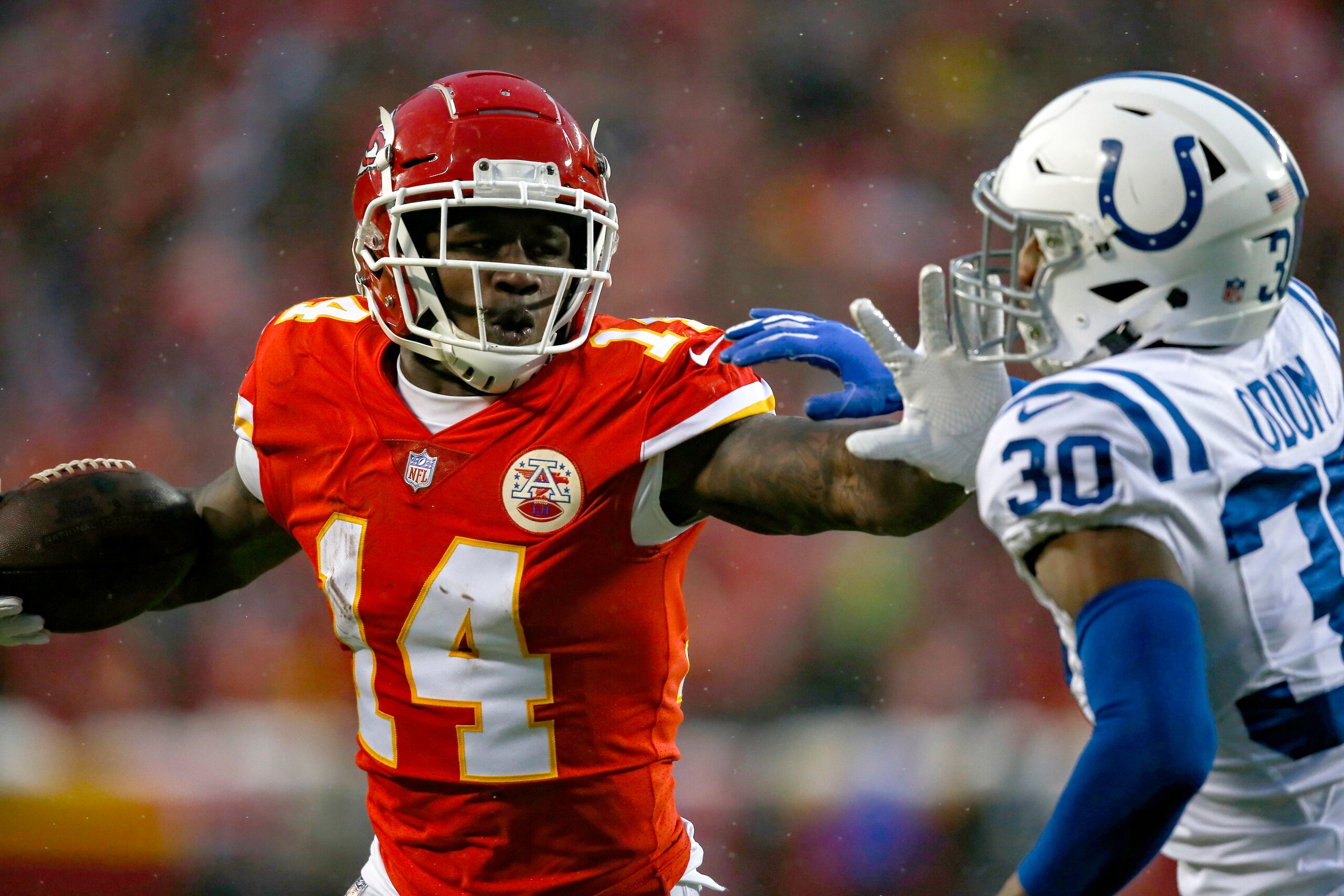 KANSAS CITY, MO - JANUARY 12: Sammy Watkins #14 of the Kansas City Chiefs stiff arms George Odum #30 of the Indianapolis Colts during the first half of the AFC Divisional Round playoff game at Arrowhead Stadium on January 12, 2019 in Kansas City, Missouri