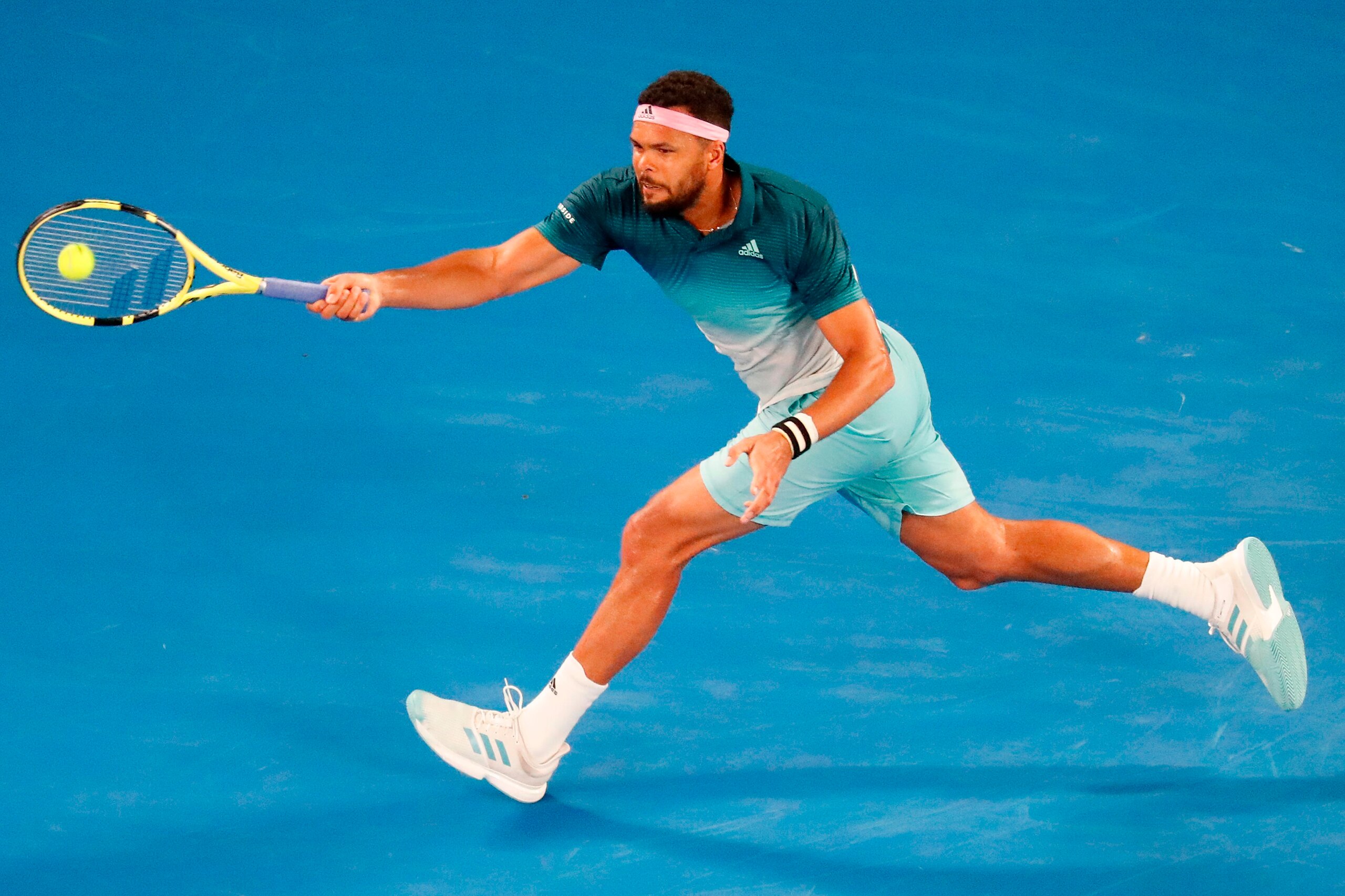 France's Jo-Wilfried Tsonga hits a return against Serbia's Novak Djokovic during their men's singles match on day four of the Australian Open tennis tournament in Melbourne on January 17, 2019. (Photo by DAVID GRAY / AFP) / -- IMAGE RESTRICTED TO EDITORIA