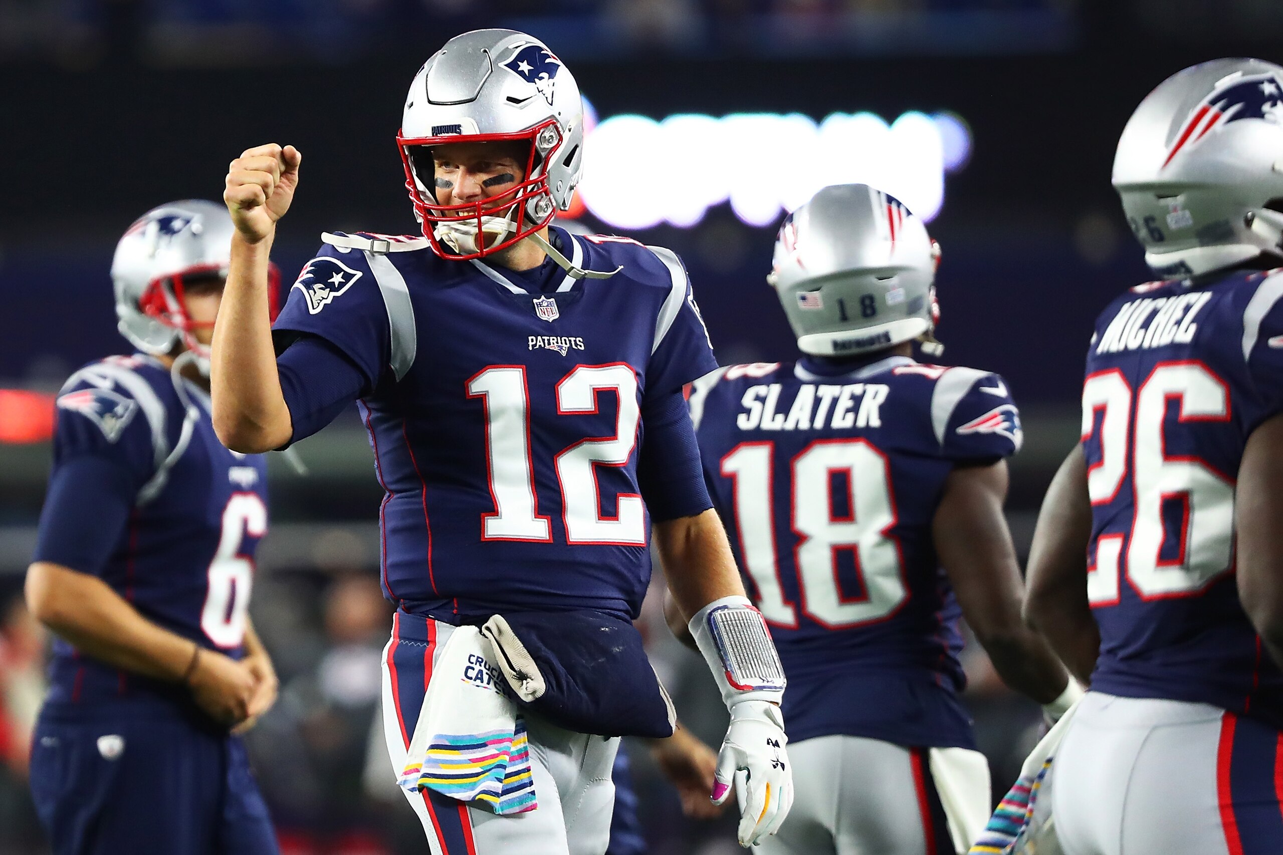 FOXBOROUGH, MA - OCTOBER 14:  Tom Brady #12 of the New England Patriots fist bumps teammates before a game against the Kansas City Chiefs at Gillette Stadium on October 14, 2018 in Foxborough, Massachusetts.  (Photo by Adam Glanzman/Getty Images)
