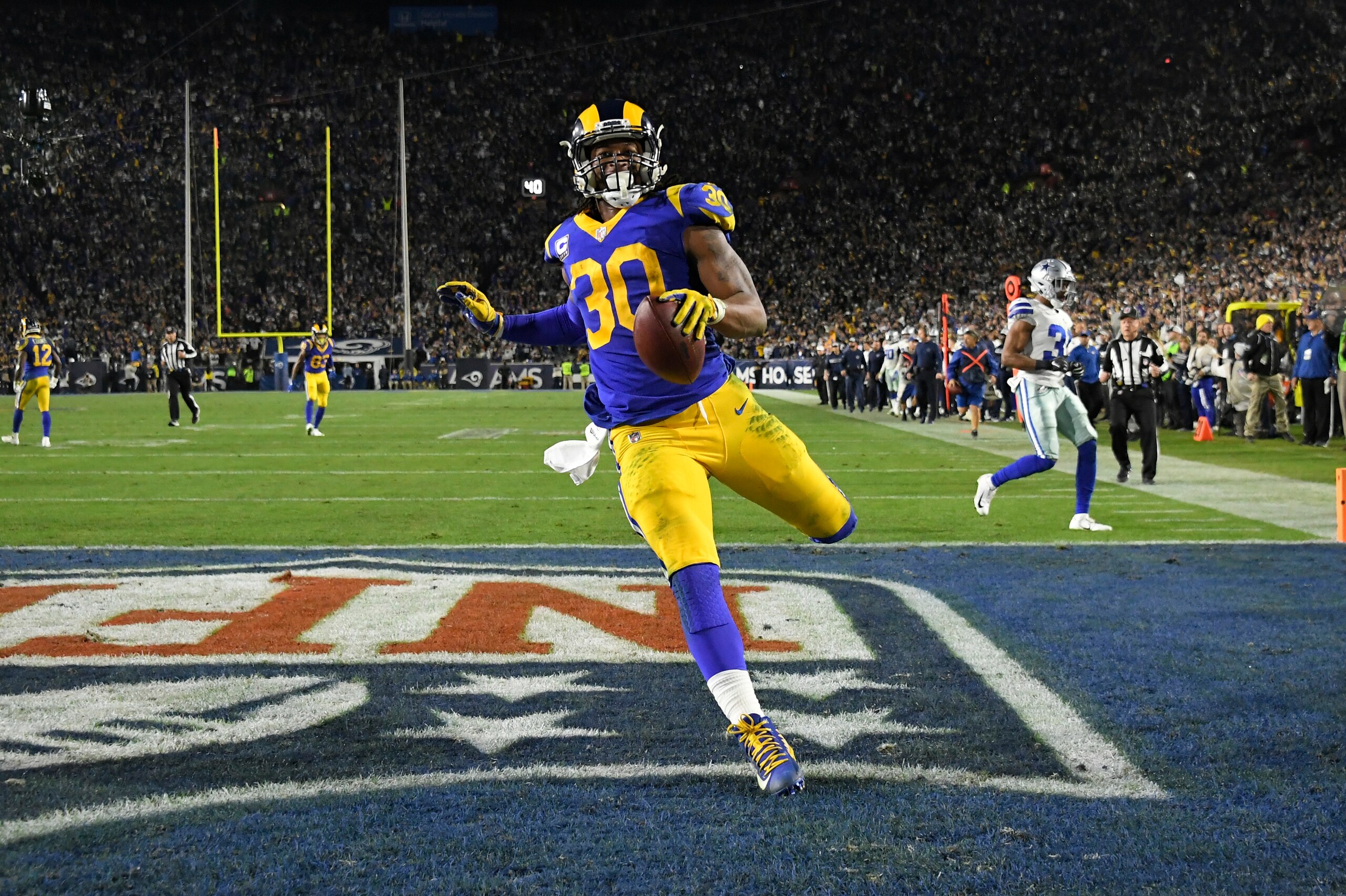 LOS ANGELES, CA - JANUARY 12: Los Angeles Rams running back Todd Gurley #30 scores a touchdown against the Dallas Cowboys at Los Angeles Memorial Coliseum on January 12, 2019 in Los Angeles, California. (Photo by John McCoy/Getty Images)