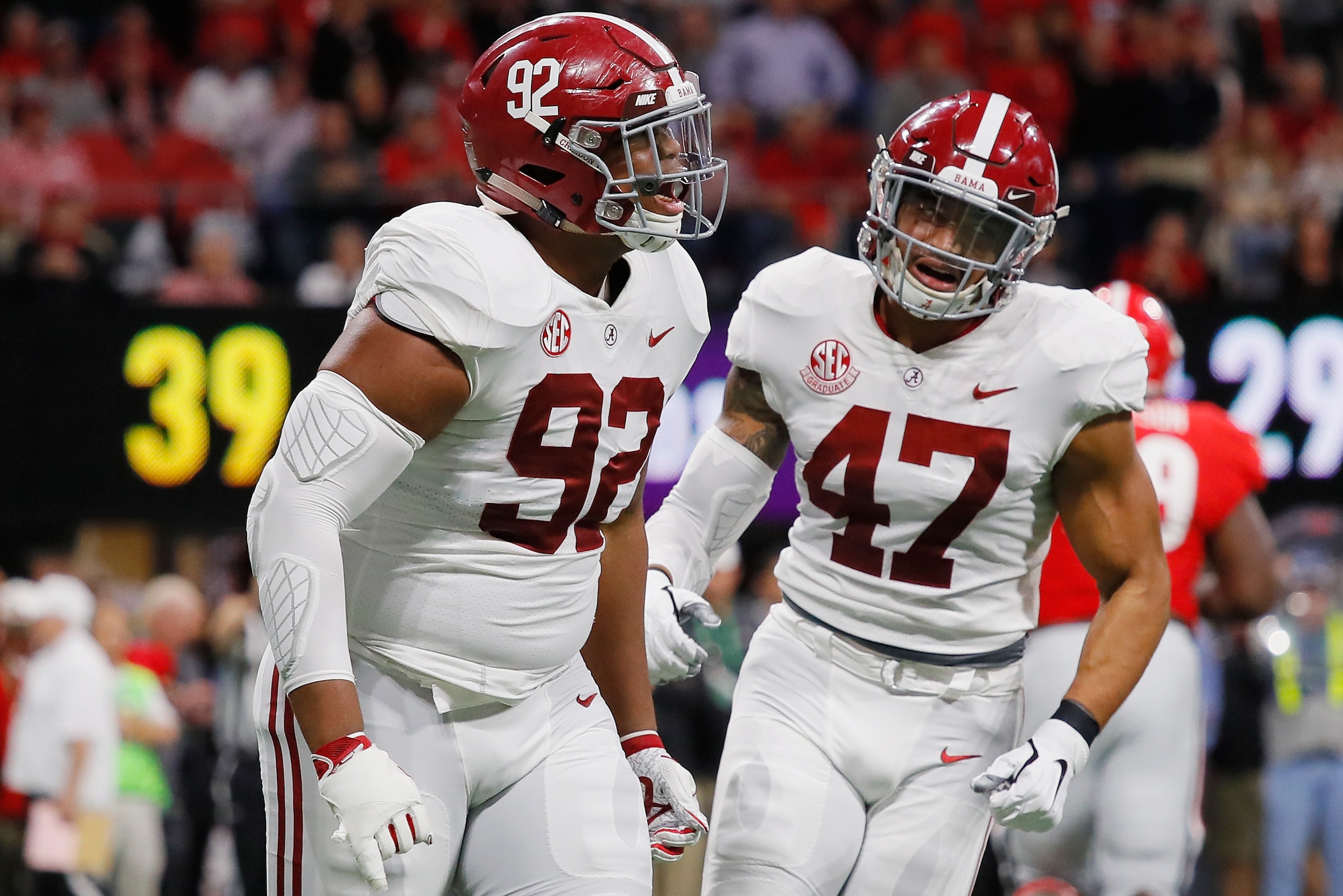 ATLANTA, GA - DECEMBER 01:  Quinnen Williams #92 of the Alabama Crimson Tide reacts with Christian Miller #47 after sacking Jake Fromm #11 of the Georgia Bulldogs (not pictured) in the first half during the 2018 SEC Championship Game at Mercedes-Benz Stad