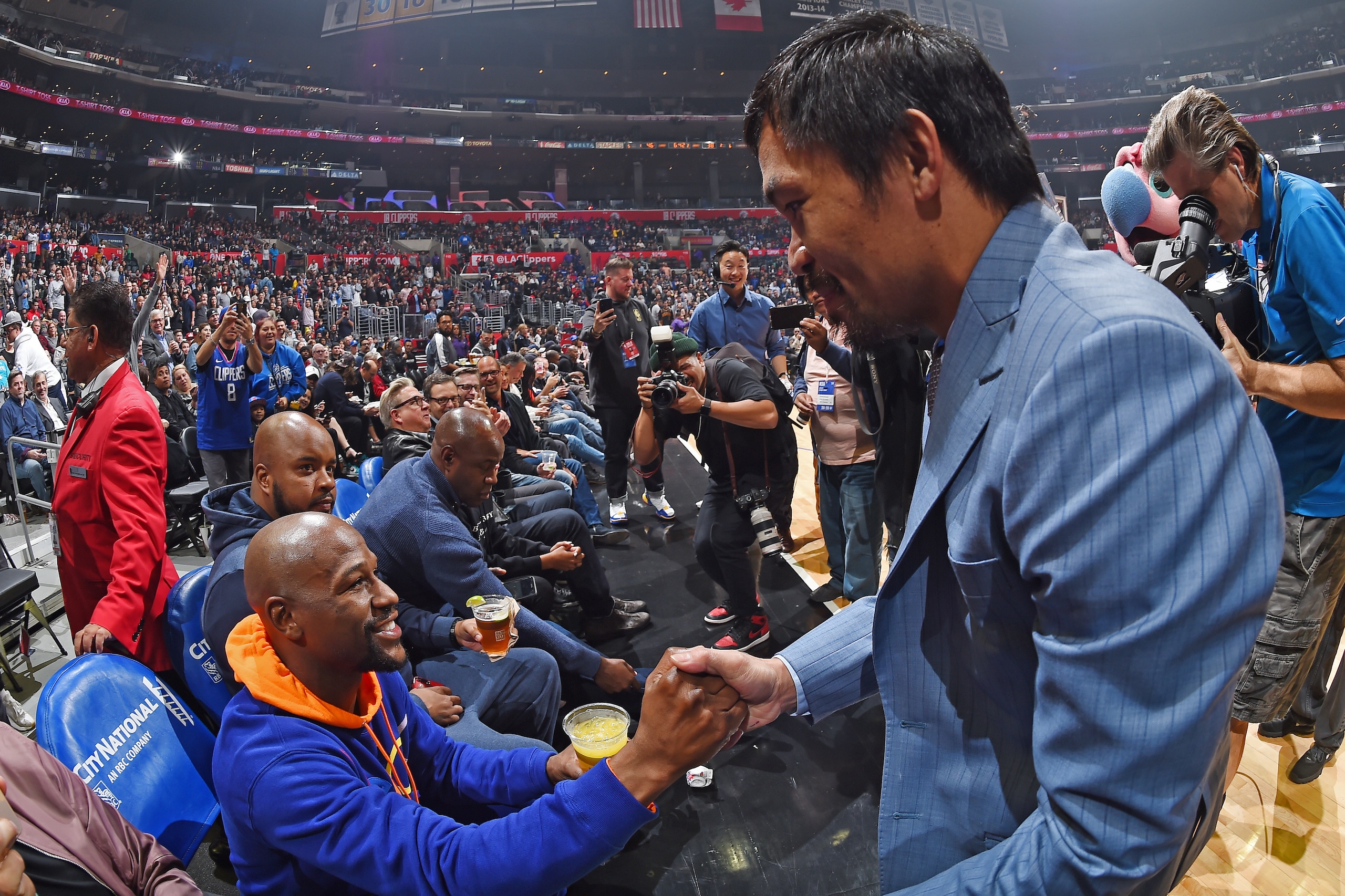 LOS ANGELES, CA - JANUARY 8: Professional Boxers Floyd Mayweather and Manny Pacquiao greet each other during the game between the Charlotte Hornets and LA Clippers on January 8, 2019 at STAPLES Center in Los Angeles, California. NOTE TO USER: User express