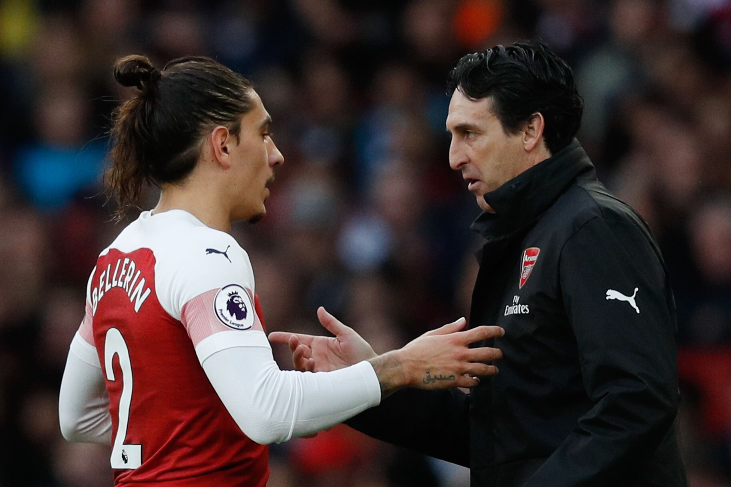Arsenal's Spanish head coach Unai Emery speaks with Arsenal's Spanish defender Hector Bellerin (L) on the touchline during the English Premier League football match between Arsenal and Tottenham Hotspur at the Emirates Stadium in London on December 2, 201
