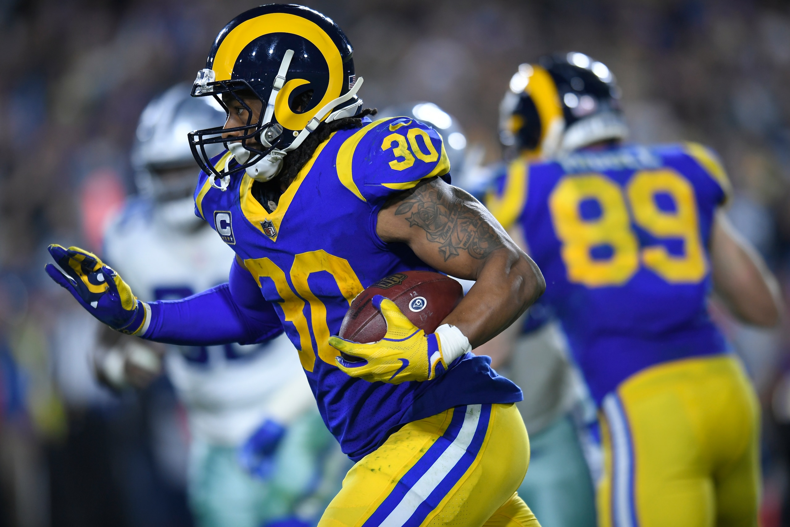 LOS ANGELES, CA - JANUARY 12: Los Angeles Rams running back Todd Gurley #30 rushes against the Dallas Cowboys at Los Angeles Memorial Coliseum on January 12, 2019 in Los Angeles, California. (Photo by John McCoy/Getty Images)