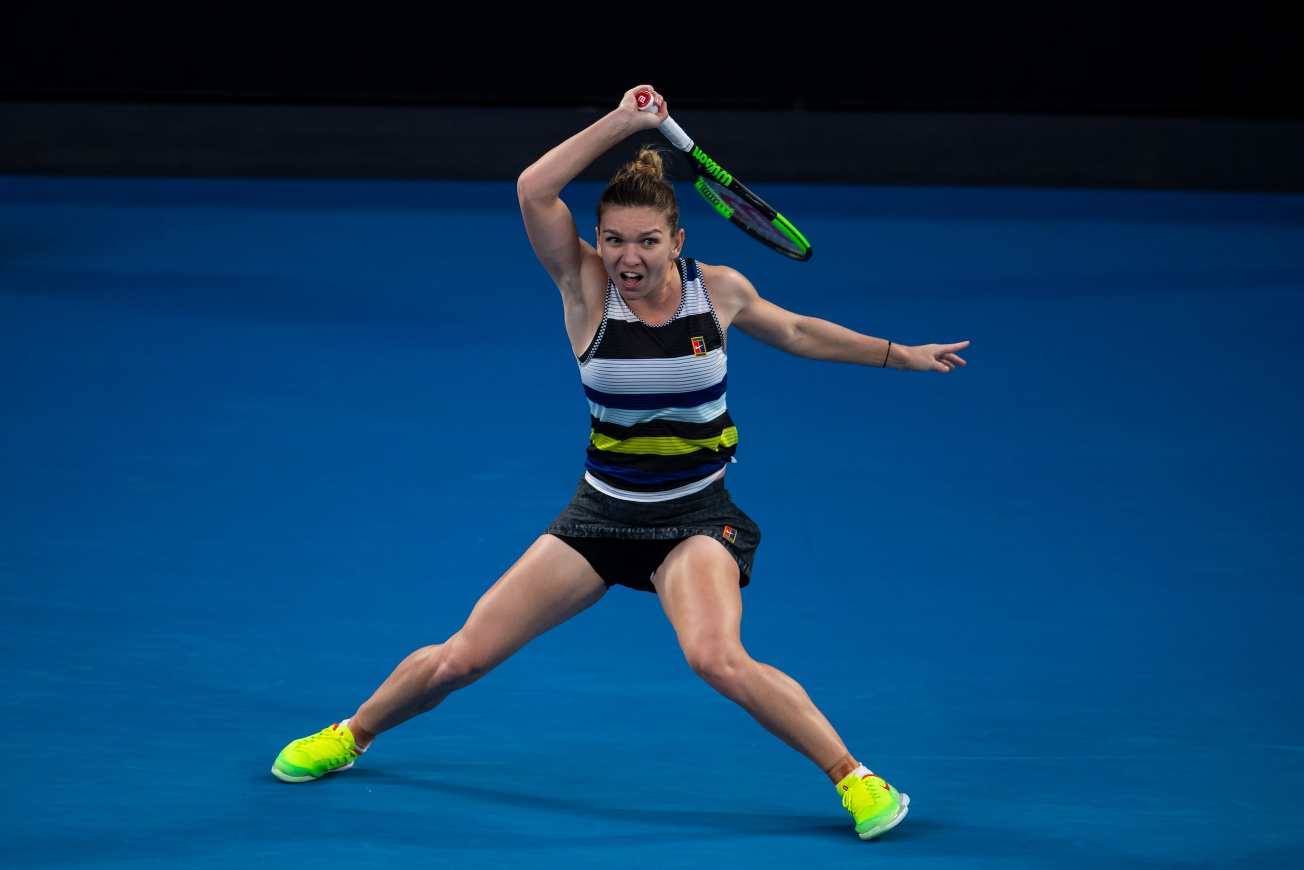 MELBOURNE, AUSTRALIA - JANUARY 21: Simona Halep of Romania hits a forehand to Serena Williams of the United States during day eight of the 2019 Australian Open at Melbourne Park on January 21, 2019 in Melbourne, Australia. (Photo by TPN/Getty Images)