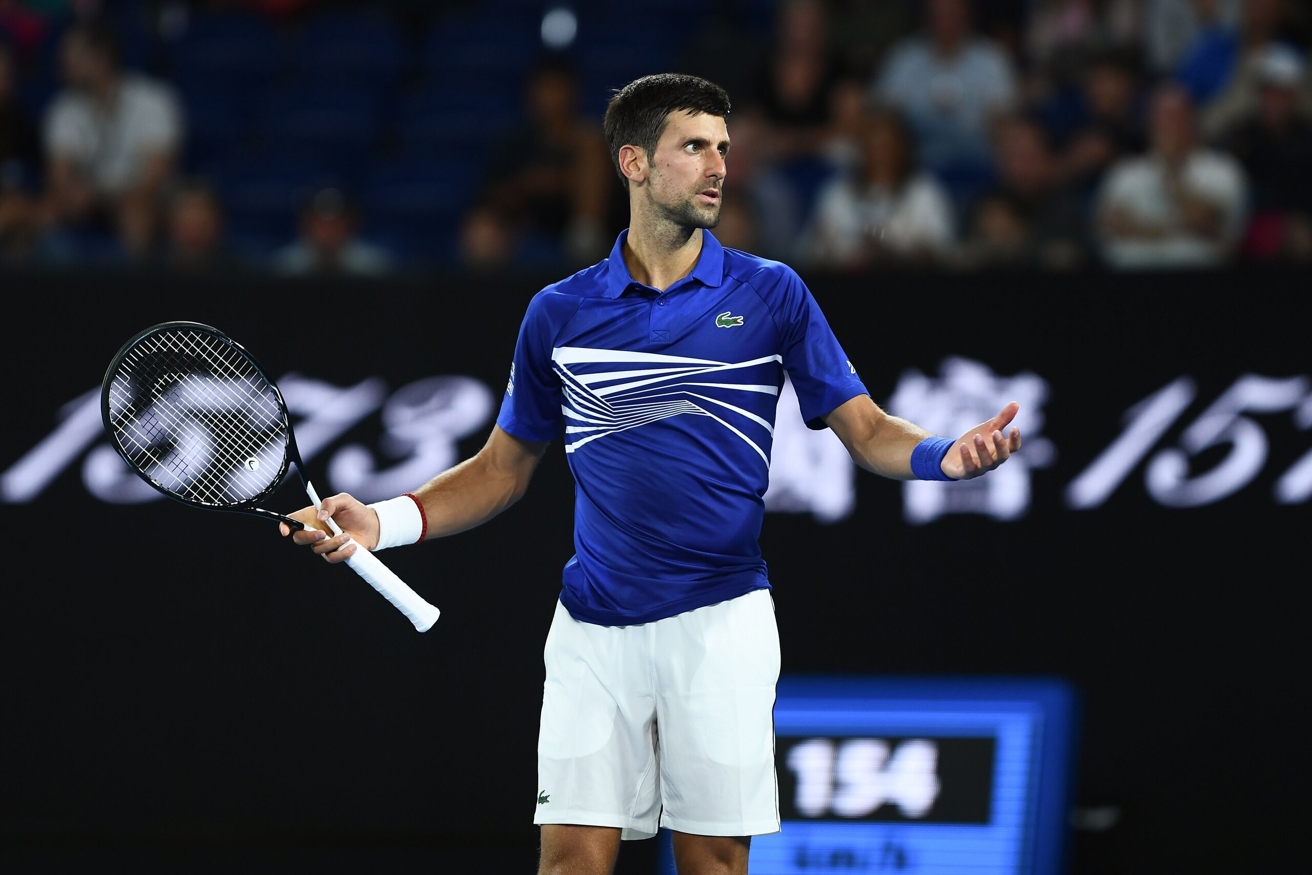 Serbia's Novak Djokovic reacts after a point against Russia's Daniil Medvedev during their men's singles match on day eight of the Australian Open tennis tournament in Melbourne early on January 22, 2019. (Photo by Jewel SAMAD / AFP) / -- IMAGE RESTRICTED