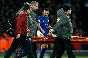 Chelsea's Spanish midfielder Pedro (C) shows concern for Arsenal's Spanish defender Hector Bellerin as he is taken off on a stretcher after picking up an injury during the English Premier League football match between Arsenal and Cheslea at the Emirates S