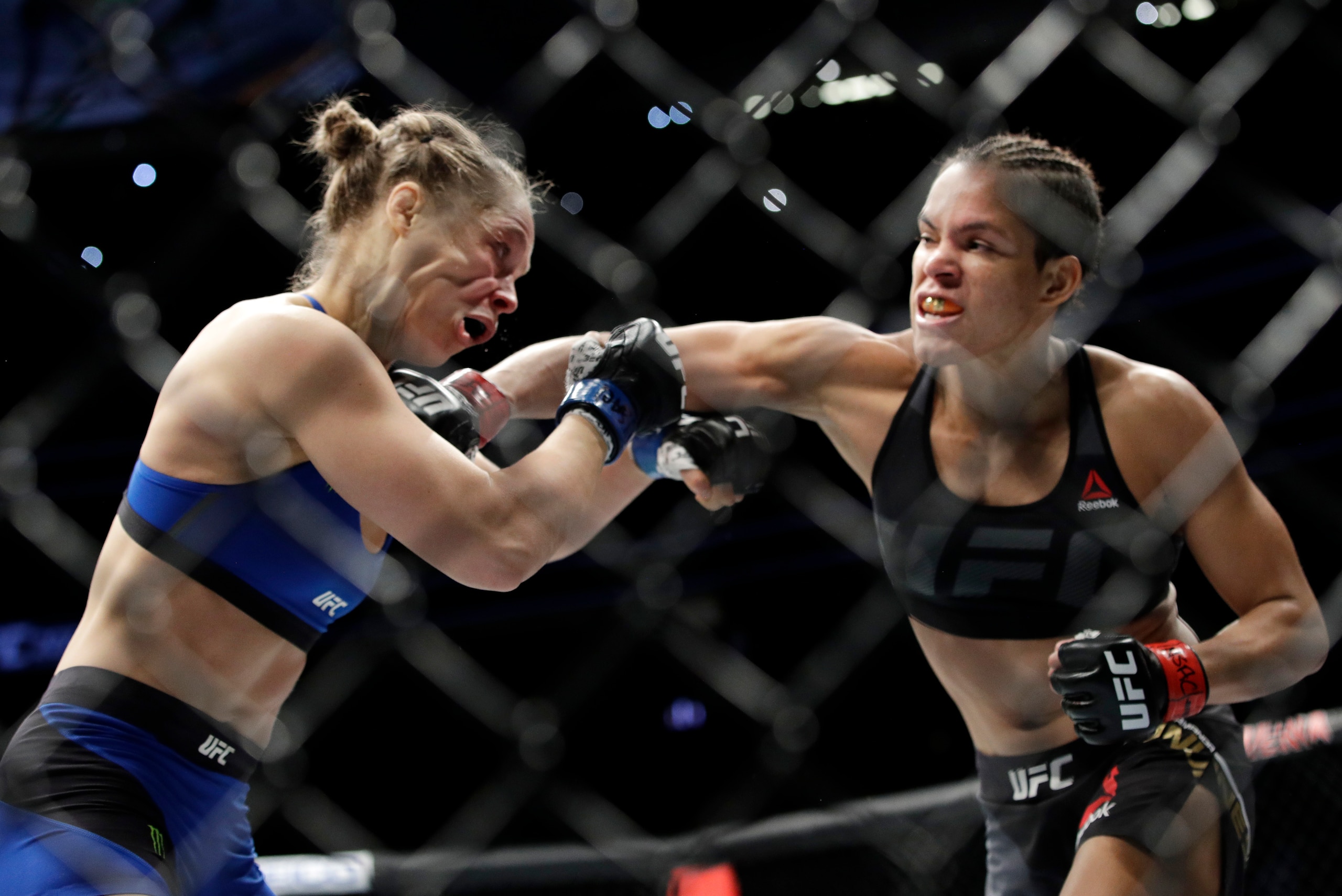 Nunes (right) punches Rousey Nunes (right) punches Rousey