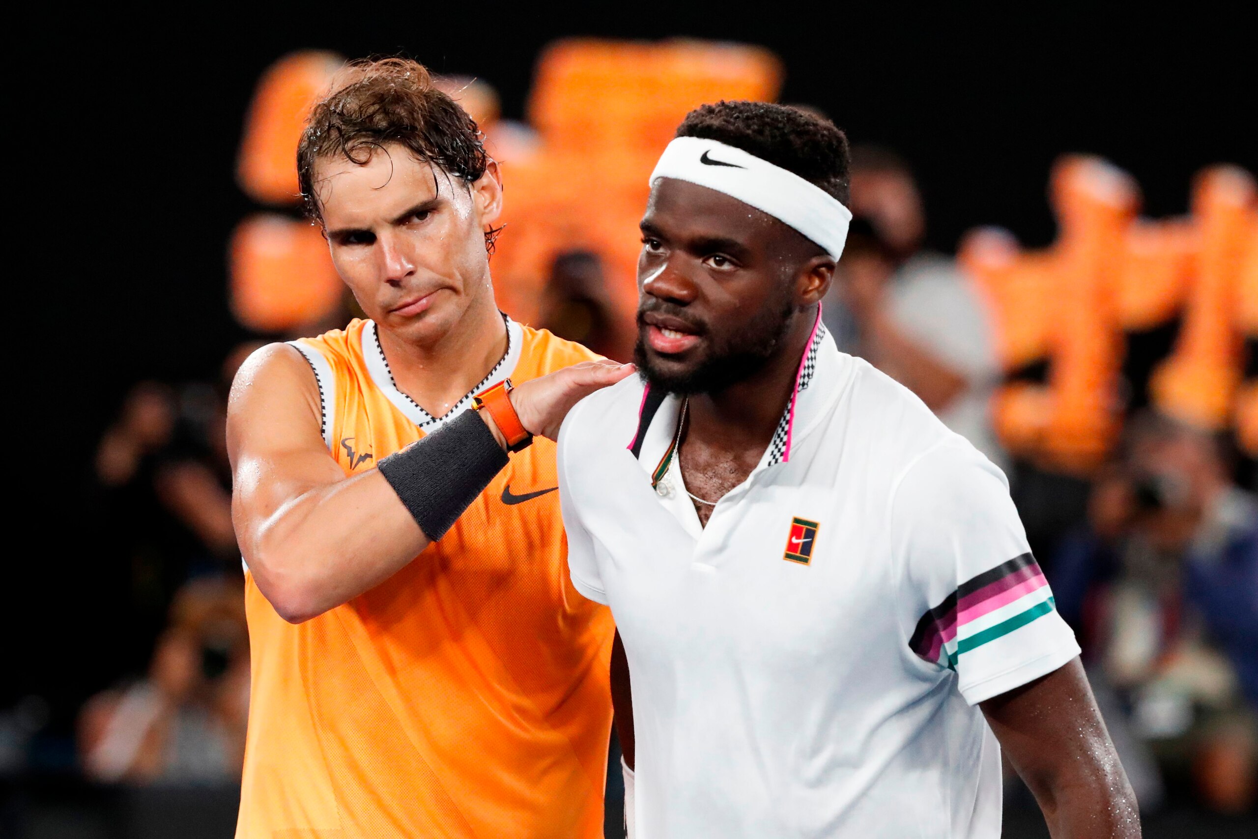 Spain's Rafael Nadal (L) embraces Frances Tiafoe of the US during their men's singles quarter-final match on day nine of the Australian Open tennis tournament in Melbourne on January 22, 2019. (Photo by DAVID GRAY / AFP) / -- IMAGE RESTRICTED TO EDITORIAL Spain's Rafael Nadal (L) embraces Frances Tiafoe of the US during their men's singles quarter-final match on day nine of the Australian Open tennis tournament in Melbourne on January 22, 2019. (Photo by DAVID GRAY / AFP) / -- IMAGE RESTRICTED TO EDITORIAL