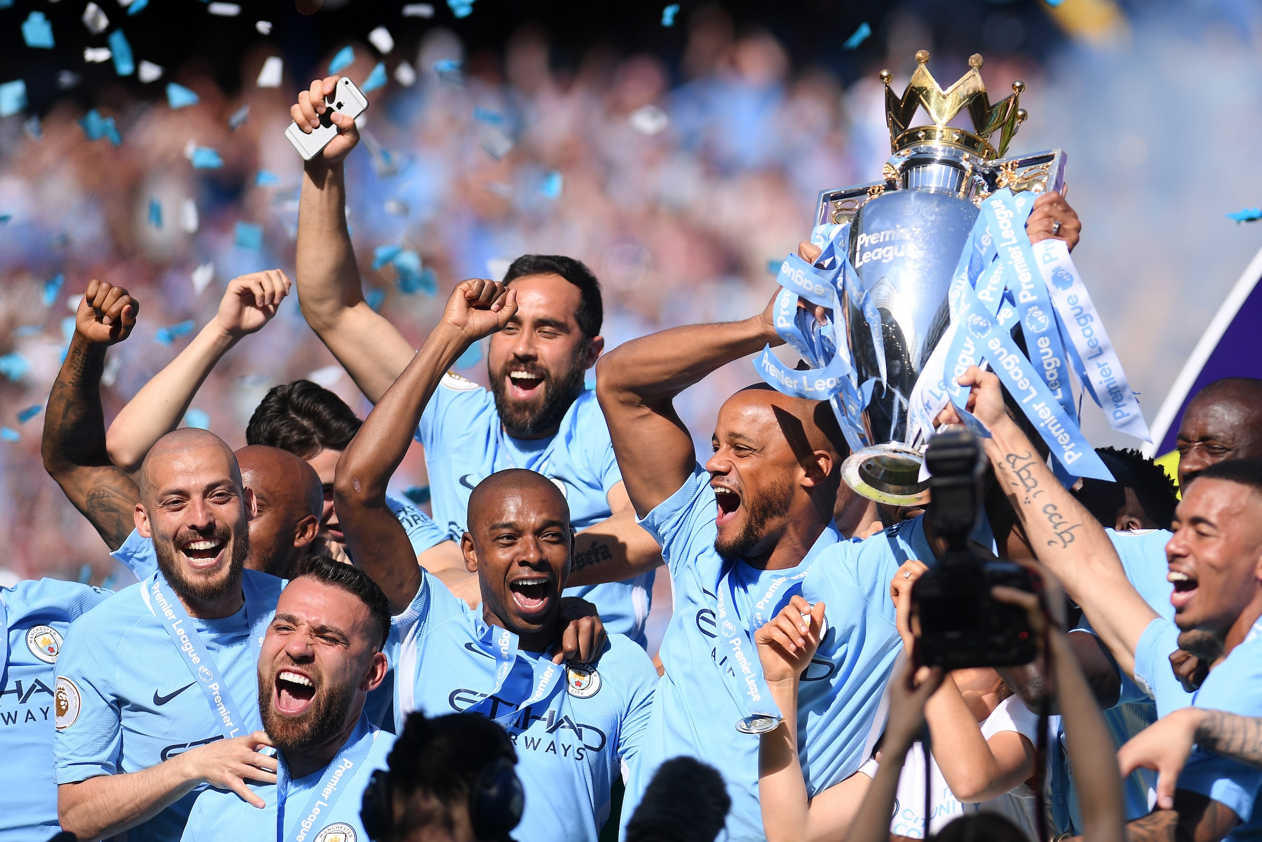 MANCHESTER, ENGLAND - MAY 06: Vincent Kompany of Manchester City lifts the Premier League Trophy alongside David Silva, Nicolas Otamendi and Fernandinho as Manchester City celebrate winning the Premier League Title during the Premier League match between MANCHESTER, ENGLAND - MAY 06: Vincent Kompany of Manchester City lifts the Premier League Trophy alongside David Silva, Nicolas Otamendi and Fernandinho as Manchester City celebrate winning the Premier League Title during the Premier League match between