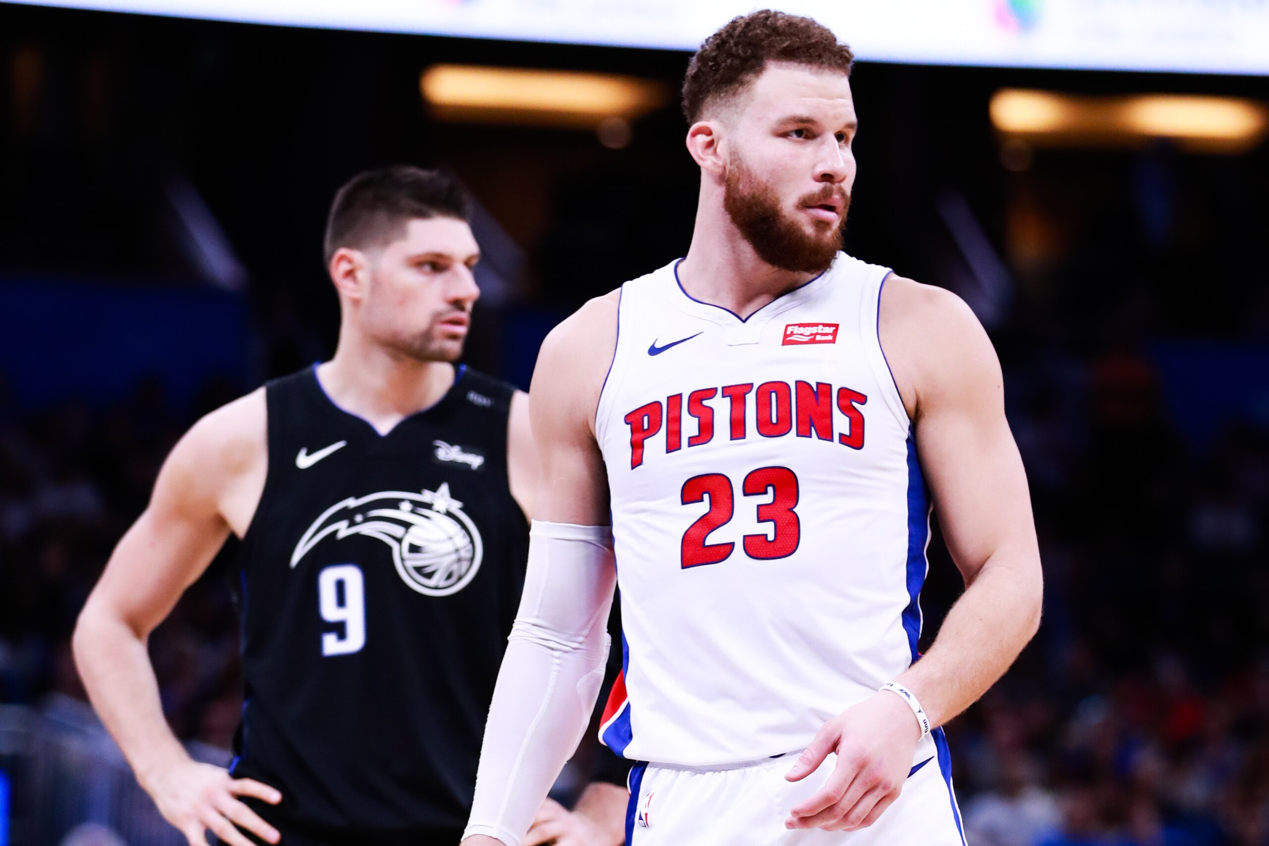 ORLANDO, FLORIDA - DECEMBER 30: Nikola Vucevic #9 of the Orlando Magic and Blake Griffin #23 of the Detroit Pistons look on between plays in the fourth quarter at Amway Center on December 30, 2018 in Orlando, Florida. NOTE TO USER: User expressly acknowle