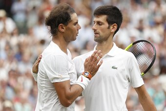 Serbia's Novak Djokovic (R) shakes hands after beating Spain's Rafael Nadal during the continuation of their men's singles semi-final match on the twelfth day of the 2018 Wimbledon Championships at The All England Lawn Tennis Club in Wimbledon, southwest 