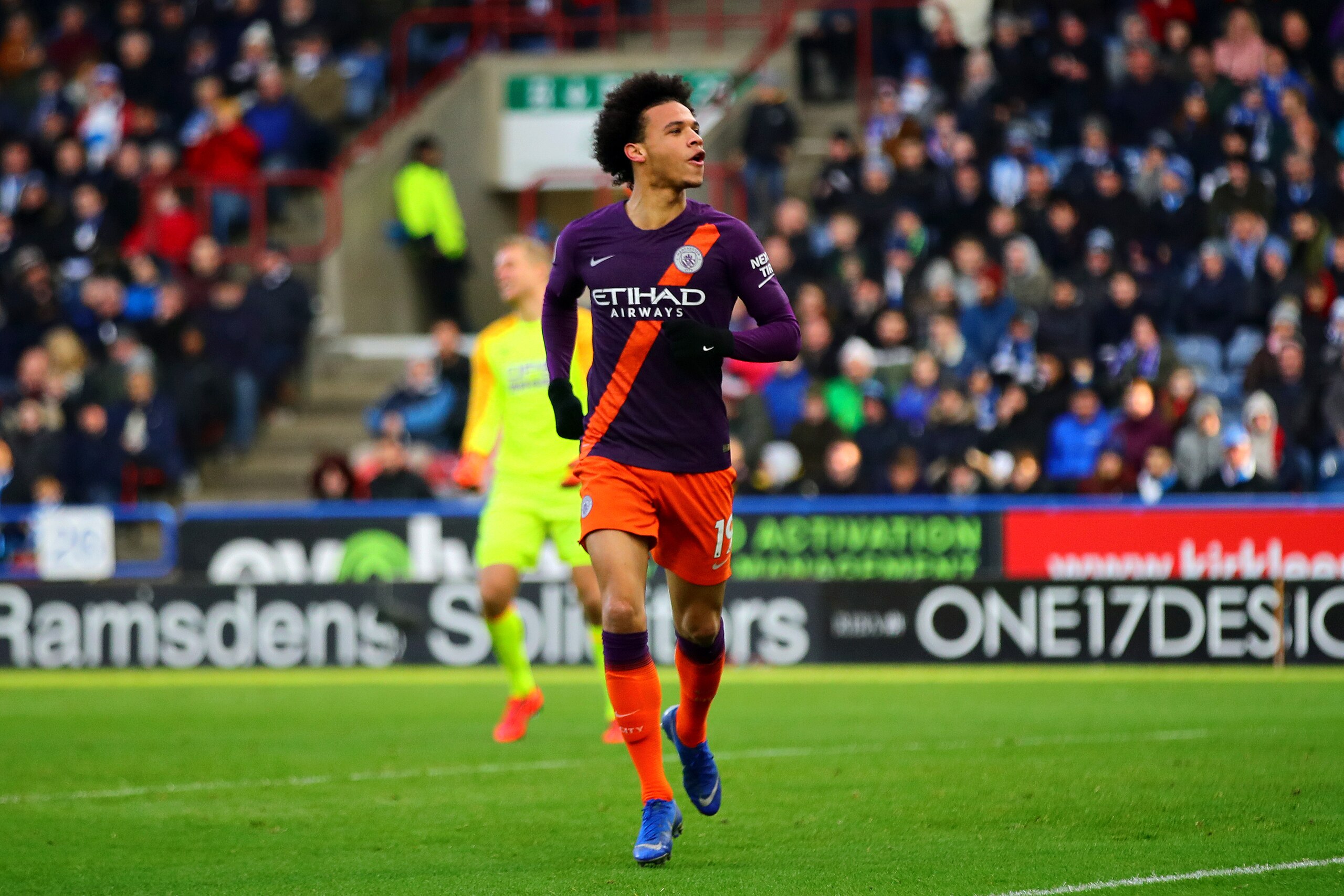 HUDDERSFIELD, ENGLAND - JANUARY 20: Leroy Sane of Manchester City celebrates scoring his sides third goal during the Premier League match between Huddersfield Town and Manchester City at John Smith's Stadium on January 20, 2019 in Huddersfield, United Kin