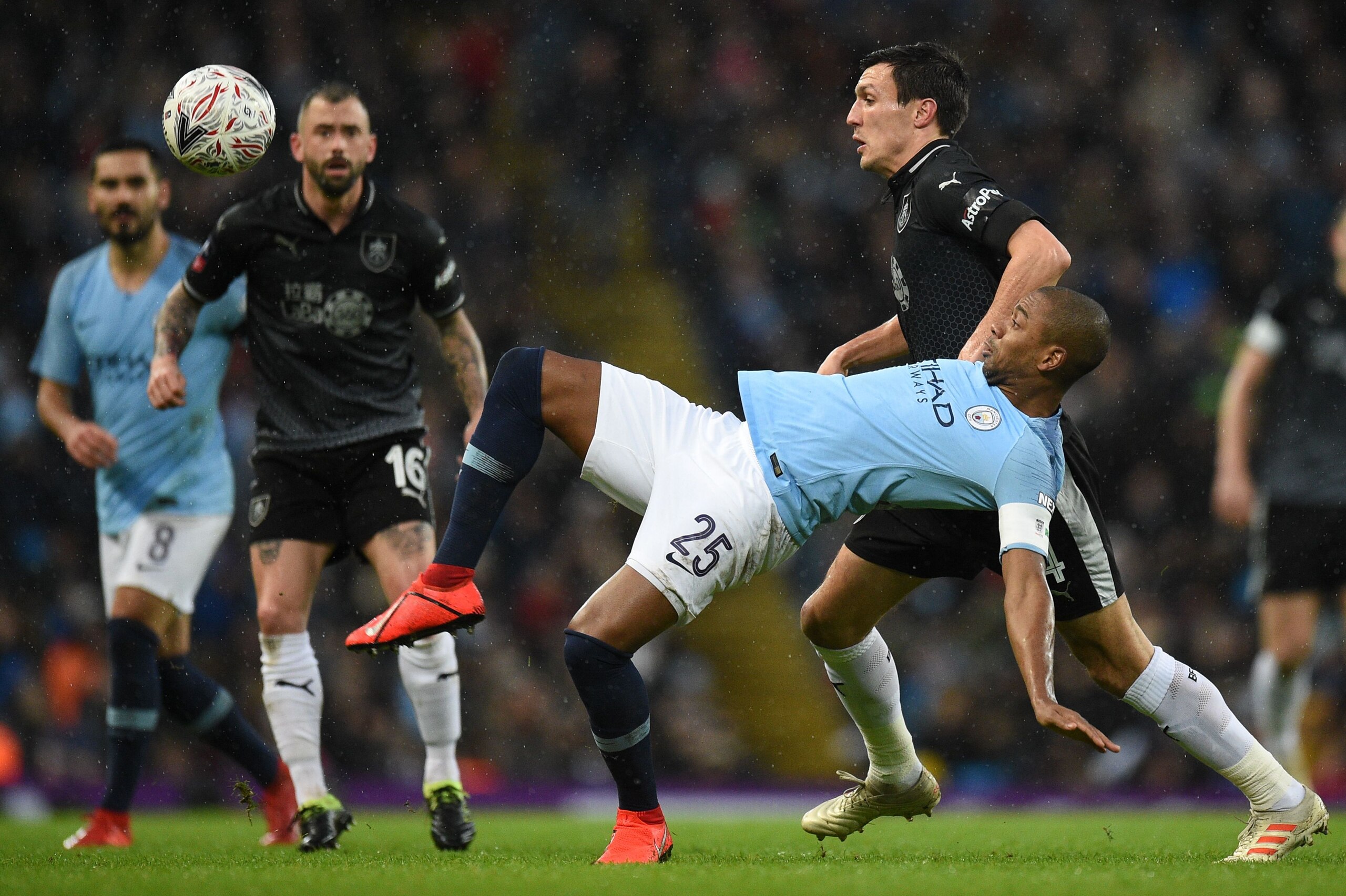 Manchester City's Brazilian midfielder Fernandinho (C) stretches for the ball during the English FA Cup fourth round football match between Manchester City and Burnley at the Etihad Stadium in Manchester, north west England, on January 26, 2019. (Photo by