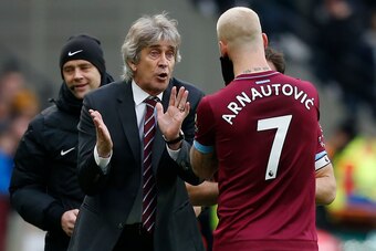 West Ham United's Chilean manager Manuel Pellegrini (2nd L) speaks with West Ham United's Austrian midfielder Marko Arnautovic (R) during a break in play during the English Premier League football match between West Ham United and Arsenal at The London St
