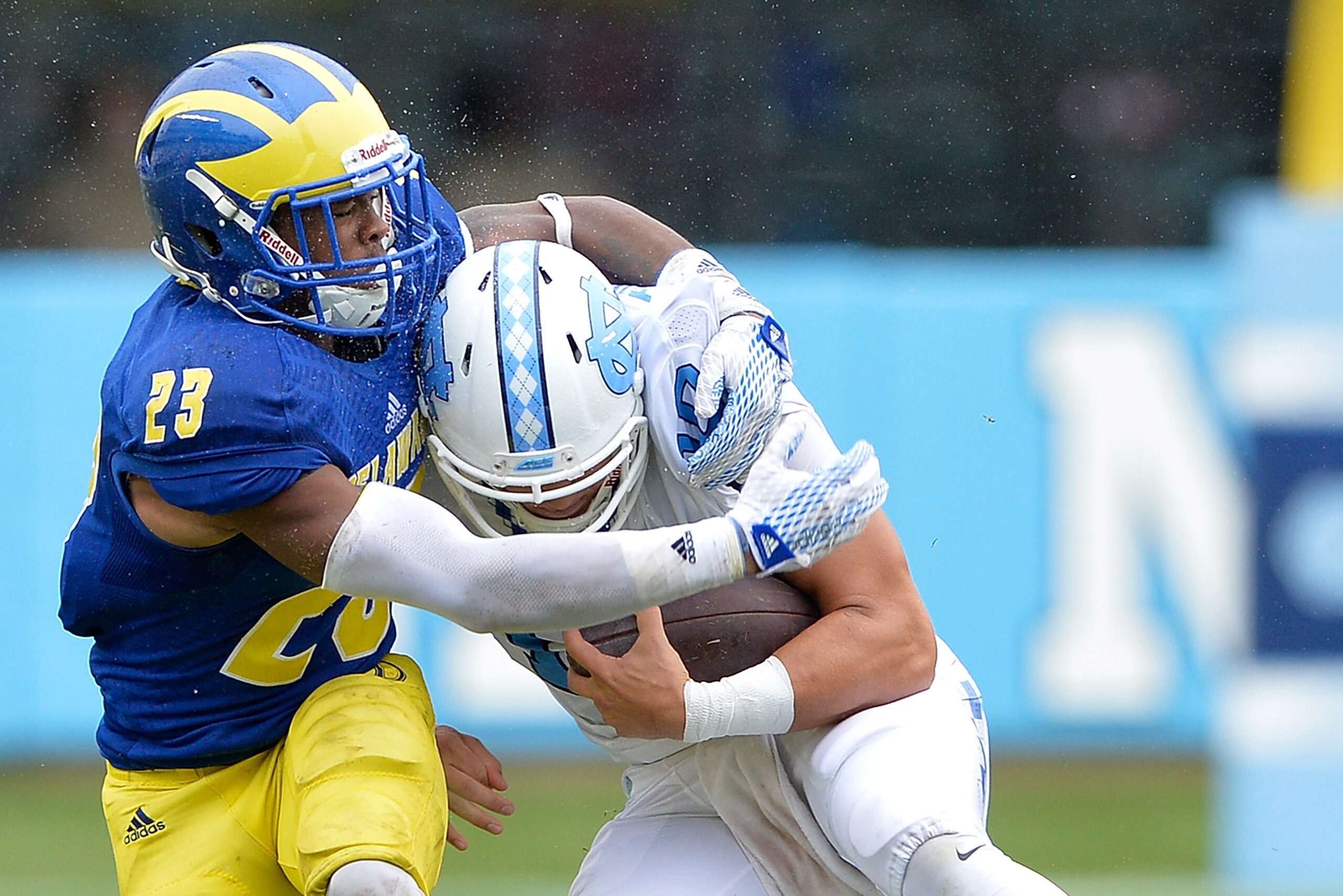 CHAPEL HILL, NC - SEPTEMBER 26: Nasir Adderley #22 of the Delaware Fightin Blue Hens tackles Mitch Trubisky #10 of the North Carolina Tar Heels during their game at Kenan Stadium on September 26, 2015 in Chapel Hill, North Carolina. North Carolina won 41-