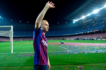 TOPSHOT - Barcelona's Spanish midfielder Andres Iniesta waves at the end of a tribute after the Spanish league football match between FC Barcelona and Real Sociedad at the Camp Nou stadium in Barcelona on May 20, 2018. - Iniesta, who joined Barcelona's ac