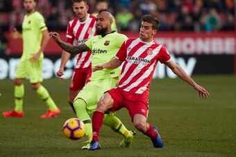 GIRONA, SPAIN - JANUARY 27: Pere Pons of Girona competes for the ball with Arturo Vidal of Barcelona during the La Liga match between Girona FC and FC Barcelona at Montilivi Stadium on January 27, 2019 in Girona, Spain. (Photo by Quality Sport Images/Gett