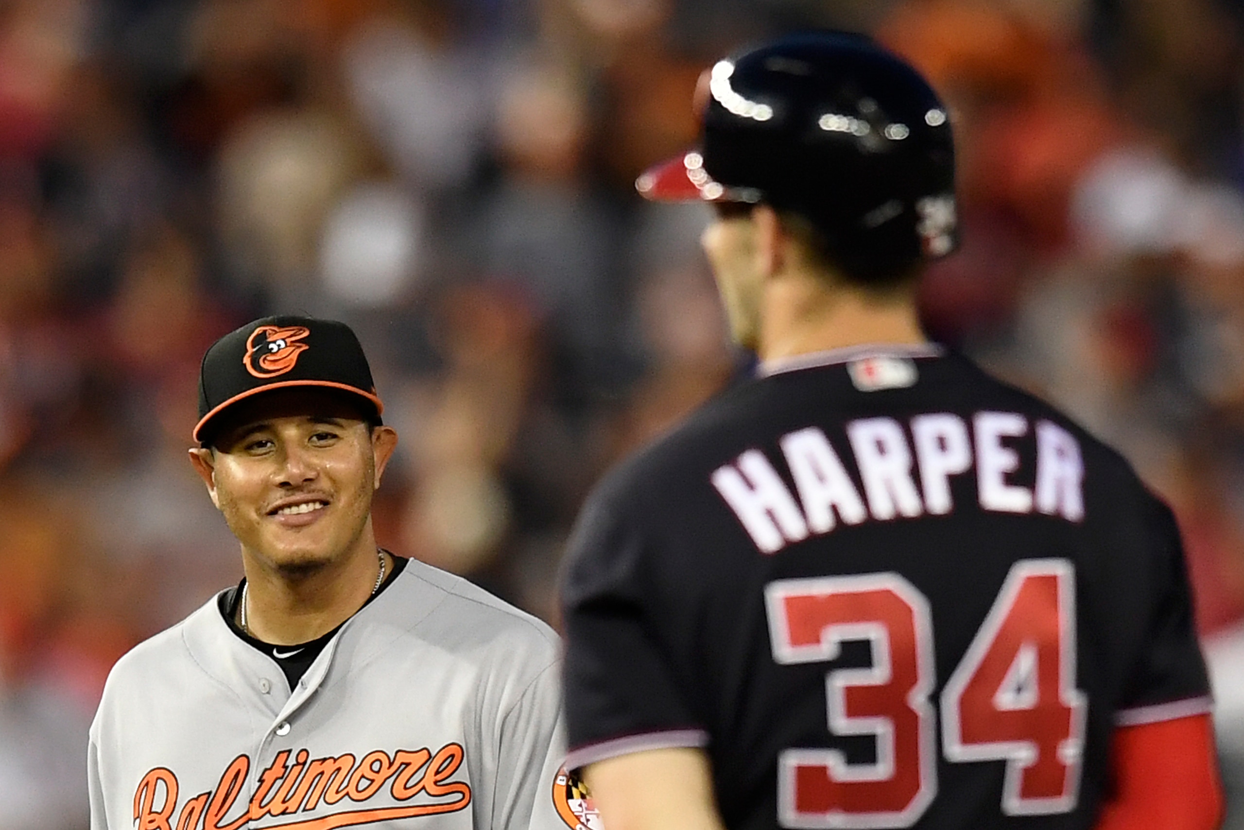 WASHINGTON, DC - JUNE 19: Bryce Harper #34 of the Washington Nationals talks with Manny Machado #13 of the Baltimore Orioles after hitting a RBI double in the fifth inning at Nationals Park on June 19, 2018 in Washington, DC. (Photo by Patrick McDermott/G