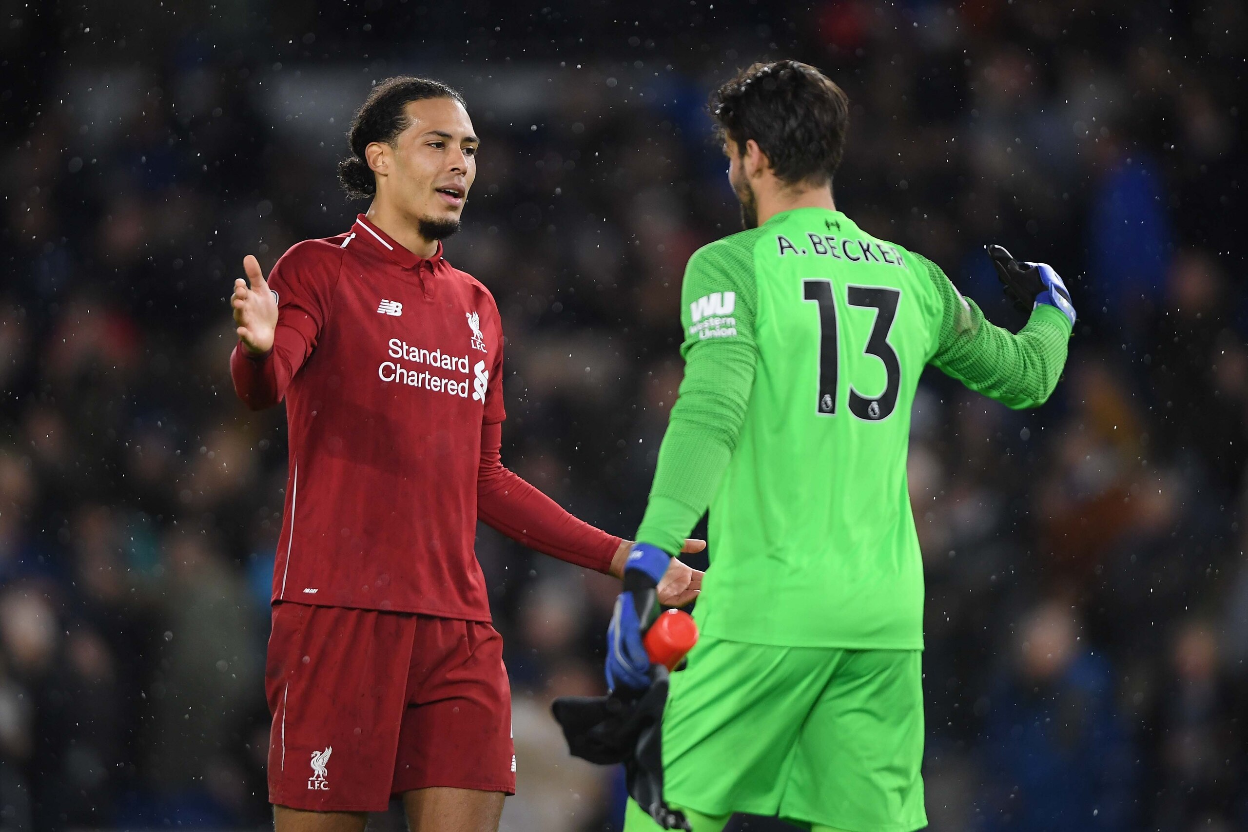 BRIGHTON, ENGLAND - JANUARY 12: Virgil van Dijk celebrates with team mate Alisson Becker of Liverpool at the end of the Premier League match between Brighton & Hove Albion and Liverpool FC at American Express Community Stadium on January 12, 2019 in Brigh BRIGHTON, ENGLAND - JANUARY 12: Virgil van Dijk celebrates with team mate Alisson Becker of Liverpool at the end of the Premier League match between Brighton & Hove Albion and Liverpool FC at American Express Community Stadium on January 12, 2019 in Brigh
