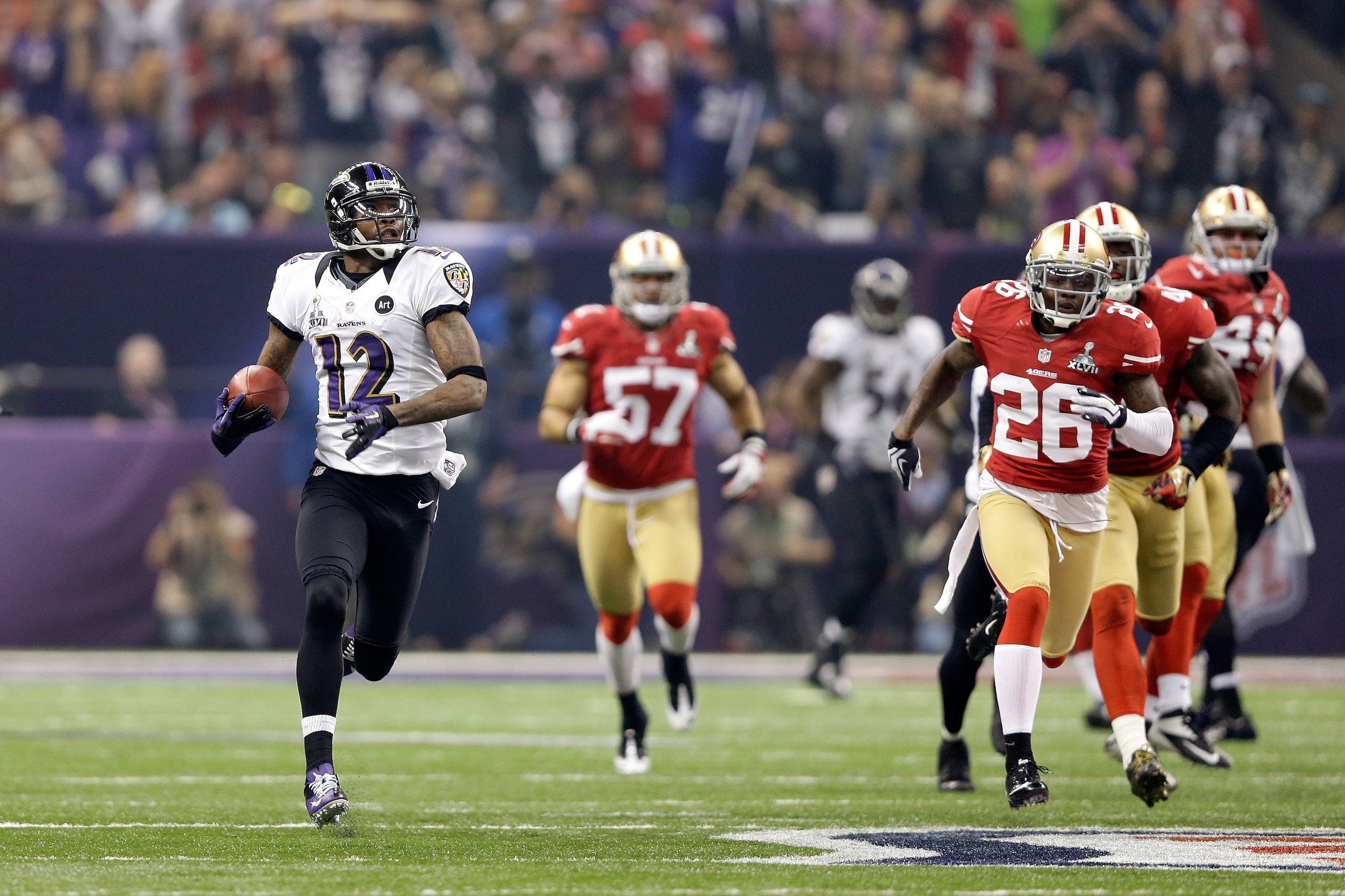 NEW ORLEANS, LA - FEBRUARY 03: Jacoby Jones #12 of the Baltimore Ravens returns the opening kick-off for the second half 108-yards for a touchdown against Tramaine Brock #26 of the San Francisco 49ers during Super Bowl XLVII at the Mercedes-Benz Superdom NEW ORLEANS, LA - FEBRUARY 03: Jacoby Jones #12 of the Baltimore Ravens returns the opening kick-off for the second half 108-yards for a touchdown against Tramaine Brock #26 of the San Francisco 49ers during Super Bowl XLVII at the Mercedes-Benz Superdom