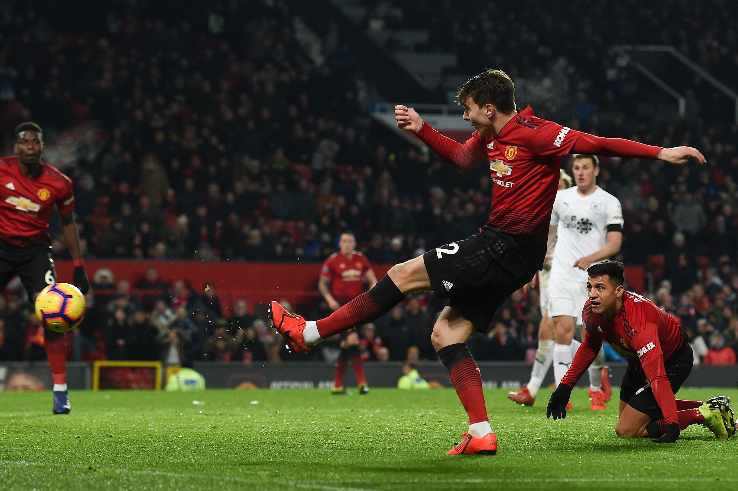 Manchester United's Swedish defender Victor Lindelof (R) shoots to score their second goal to equalise 2-2 during the English Premier League football match between Manchester United and Burnley at Old Trafford in Manchester, north west England, on January