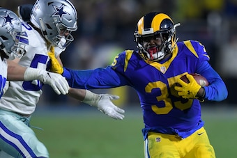 LOS ANGELES, CA - JANUARY 12: Los Angeles Rams running back C.J. Anderson #35 stiff arms Dallas Cowboys outside linebacker Leighton Vander Esch #55 at Los Angeles Memorial Coliseum on January 12, 2019 in Los Angeles, California. (Photo by John McCoy/Getty