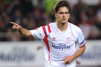 Sevilla's midfielder Denis Suarez celebrates after scoring a goal against Rijeka during the UEFA Europa League Group G football match Sevilla FC vs HNK Rijeka at the Ramon Sanchez Pizjuan stadium in Sevilla on December 11, 2014.     AFP PHOTO/ CRISTINA QU
