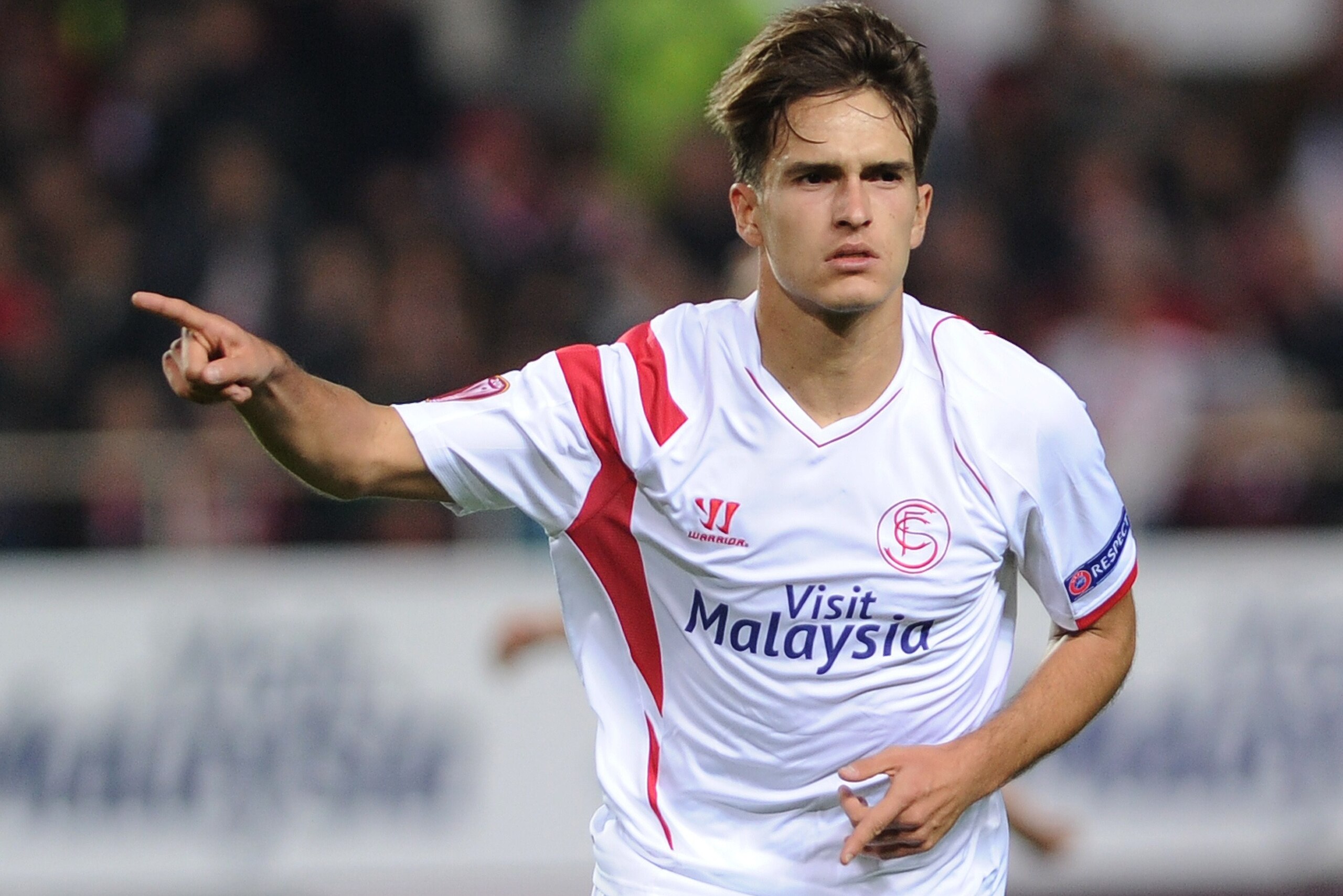 Sevilla's midfielder Denis Suarez celebrates after scoring a goal against Rijeka during the UEFA Europa League Group G football match Sevilla FC vs HNK Rijeka at the Ramon Sanchez Pizjuan stadium in Sevilla on December 11, 2014.     AFP PHOTO/ CRISTINA QU