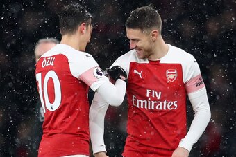 LONDON, ENGLAND - JANUARY 29:  Mesut Ozil of Arsenal hands the captains arm band to Aaron Ramsey of Arsenal  during the Premier League match between Arsenal and Cardiff City at Emirates Stadium on January 29, 2019 in London, United Kingdom.  (Photo by Cat