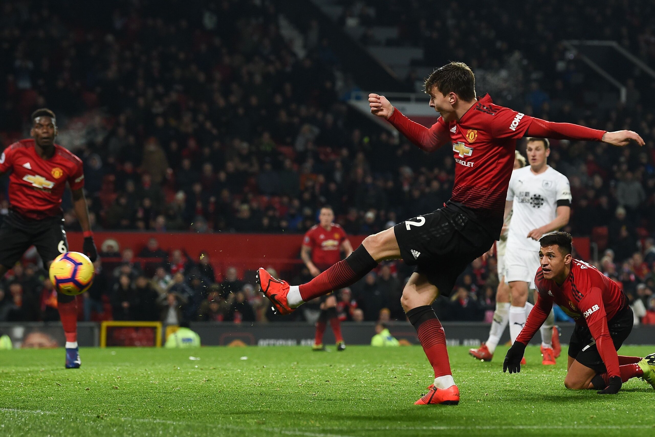 Manchester United's Swedish defender Victor Lindelof (R) shoots to score their second goal to equalise 2-2 during the English Premier League football match between Manchester United and Burnley at Old Trafford in Manchester, north west England, on January