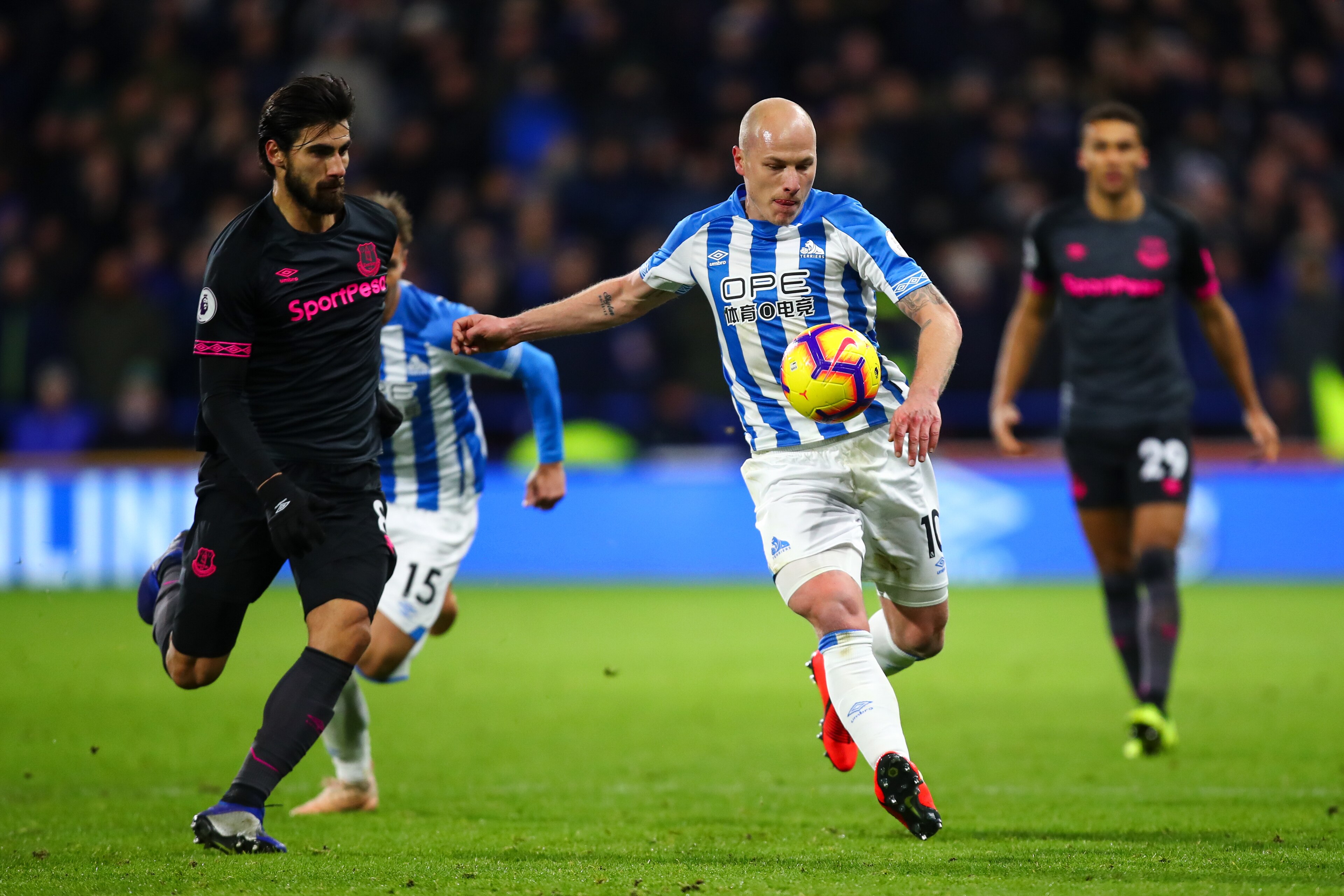 HUDDERSFIELD, ENGLAND - JANUARY 29: Andre Gomes of Everton and Aaron Mooy of Huddersfield Town during the Premier League match between Huddersfield Town and Everton FC at John Smith's Stadium on January 29, 2019 in Huddersfield, United Kingdom. (Photo by 