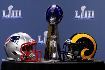 ATLANTA, GA - JANUARY 30:  Detail of the Lombardi Trophy and the helmets of the New England Patriots (left) and the Los Angeles Rams priot to NFL Commissioner Roger Goodell speaking during a press conference during Super Bowl LIII Week at the NFL Media Ce