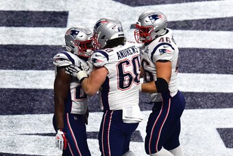 ATLANTA, GEORGIA - FEBRUARY 03:  David Andrews #60 and James Develin #46  congratulate Sony Michel #26 of the New England Patriots after his fourth quarter touchdown against Los Angeles Rams during Super Bowl LIII at Mercedes-Benz Stadium on February 03, 