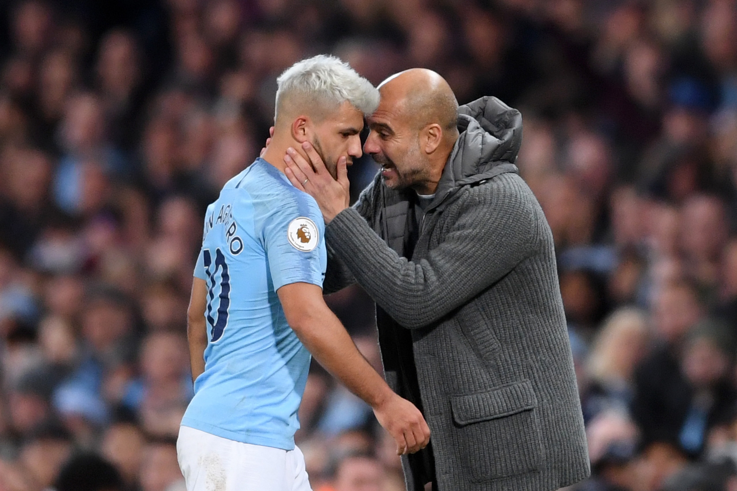 MANCHESTER, ENGLAND - NOVEMBER 11:  Sergio Aguero of Manchester City is embraced by Josep Guardiola, Manager of Manchester City as he is substituted during the Premier League match between Manchester City and Manchester United at Etihad Stadium on Novembe