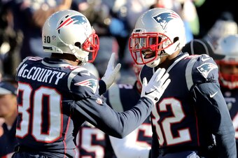 FOXBOROUGH, MASSACHUSETTS - JANUARY 13: Jason McCourty #30 of the New England Patriots and Devin McCourty #32 react during the second quarter in the AFC Divisional Playoff Game against the Los Angeles Chargers at Gillette Stadium on January 13, 2019 in Fo