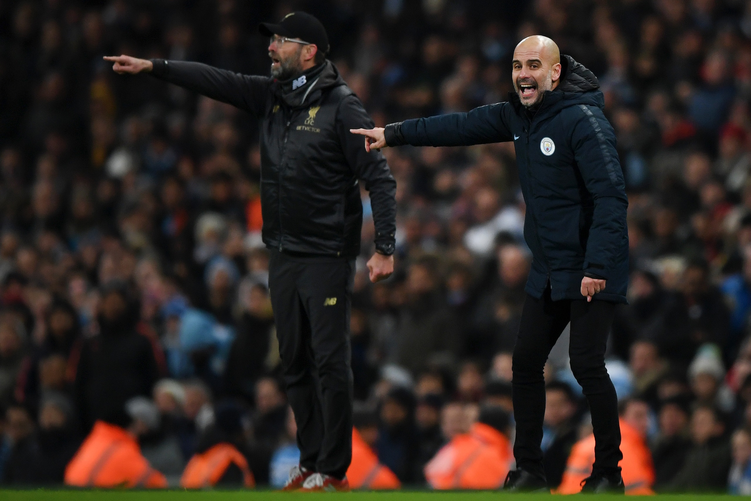 MANCHESTER, ENGLAND - JANUARY 03: Josep Guardiola, Manager of Manchester City and Jurgen Klopp, Manager of Liverpool give their team instructions during the Premier League match between Manchester City and Liverpool FC at the Etihad Stadium on January 3, 