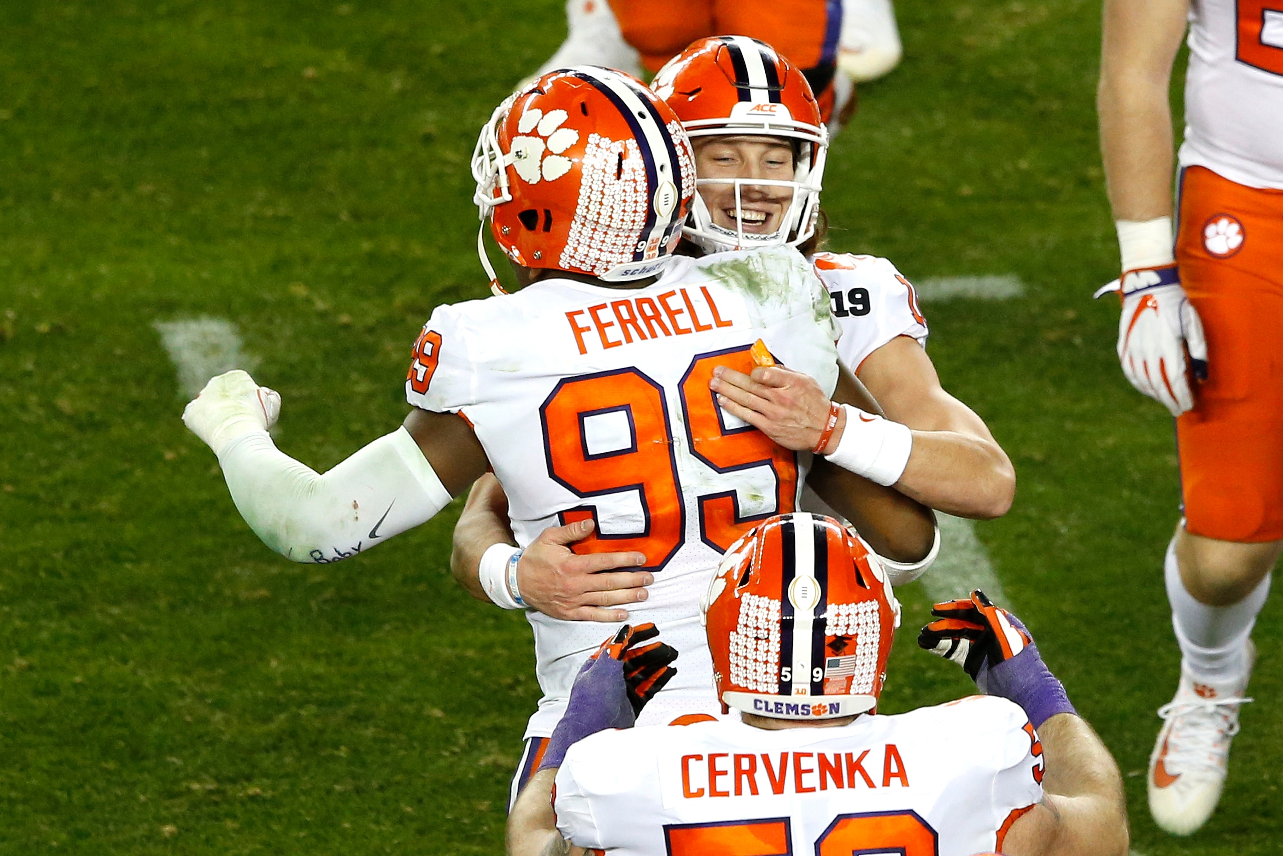 SANTA CLARA, CALIFORNIA - JANUARY 07: Trevor Lawrence #16 of the Clemson Tigers celebrates with teammate Clelin Ferrell #99 against the Alabama Crimson Tide during the fourth quarter in the College Football Playoff National Championship at Levi's Stadium 